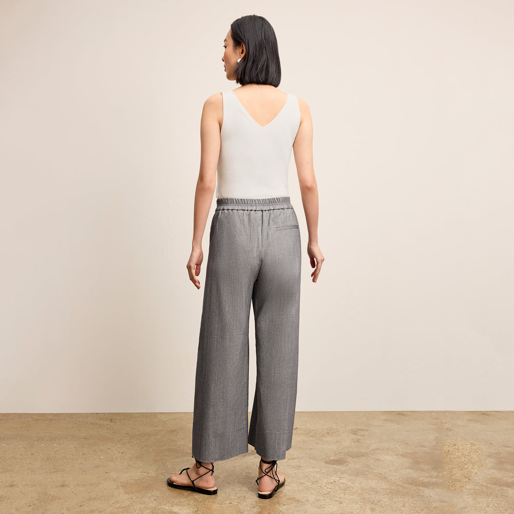 Back image of a woman standing wearing the Peggy top in ivory