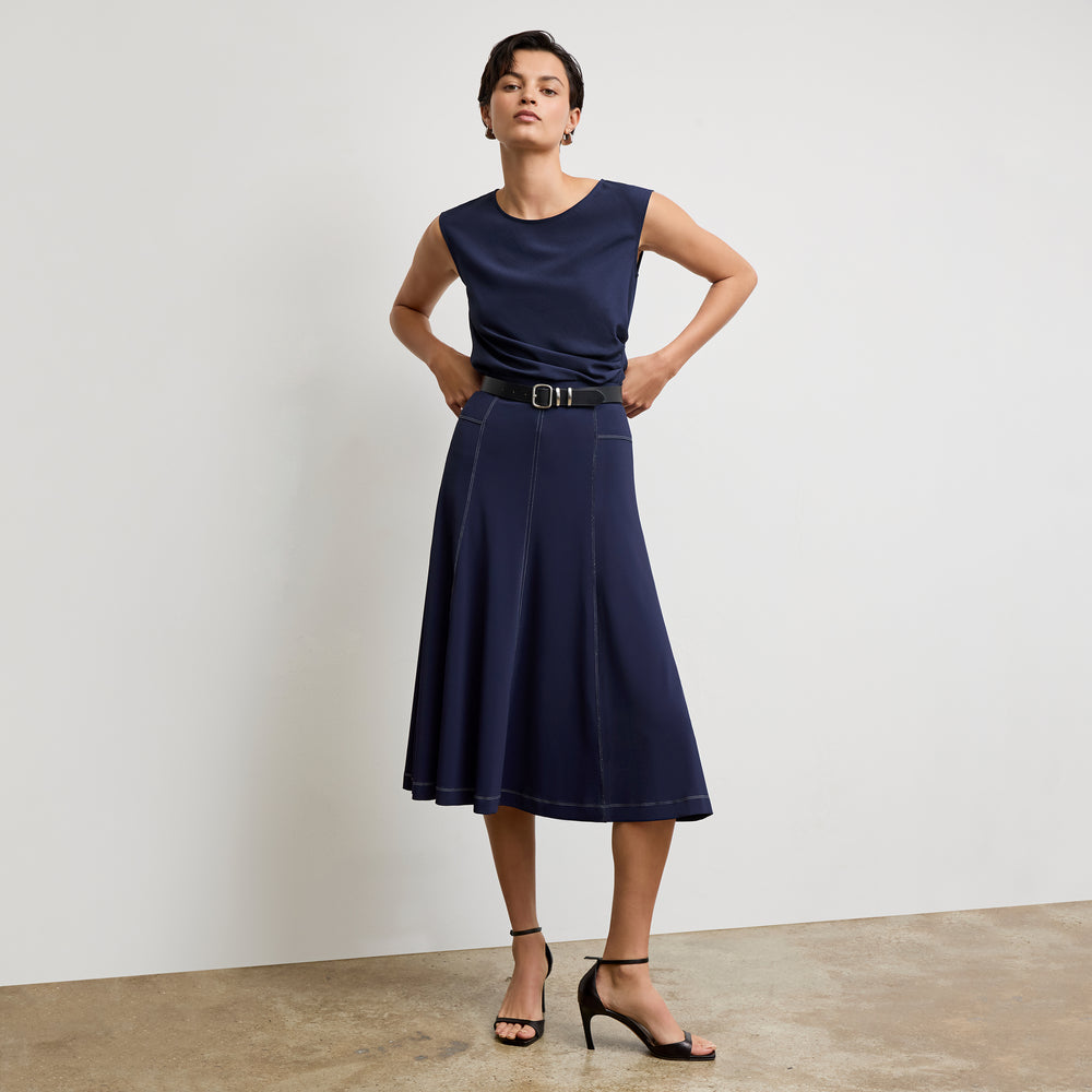 front image of a woman wearing the shannon skirt in soft navy