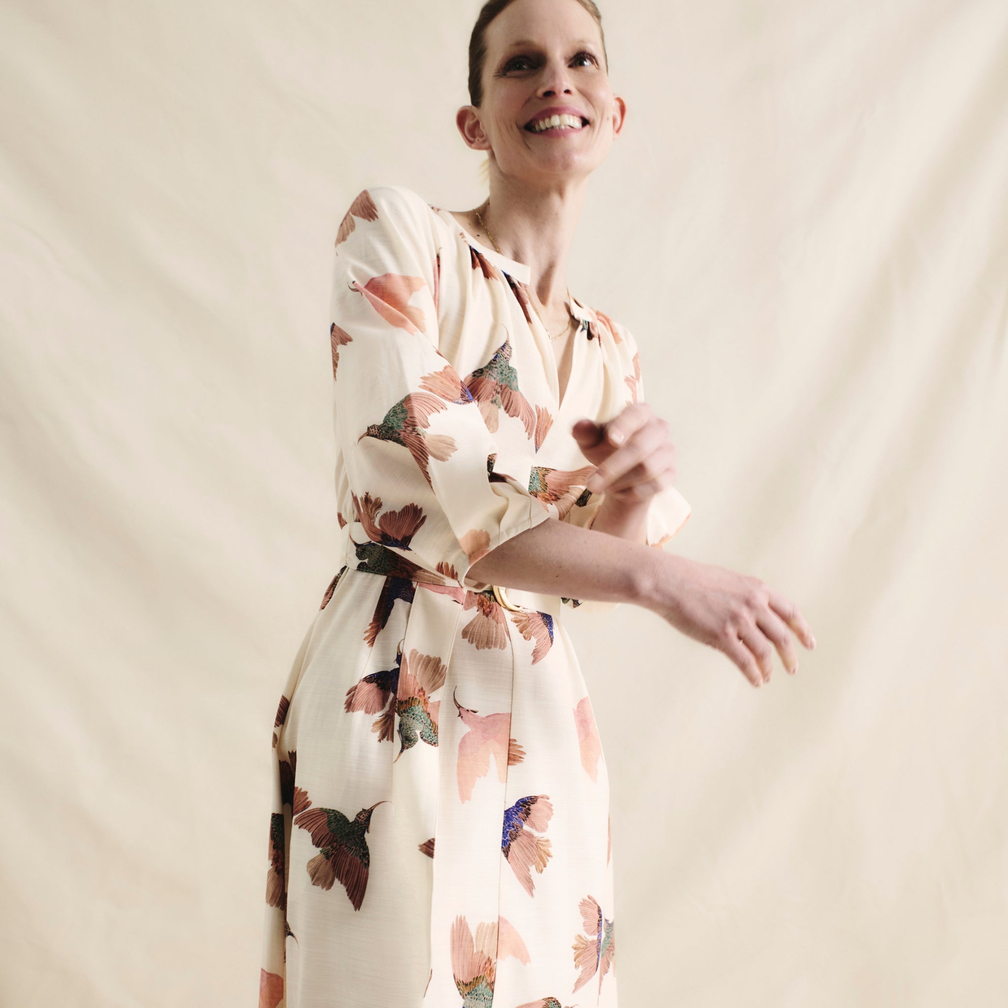 front image of a woman wearing the tessie dress in hummingbird print