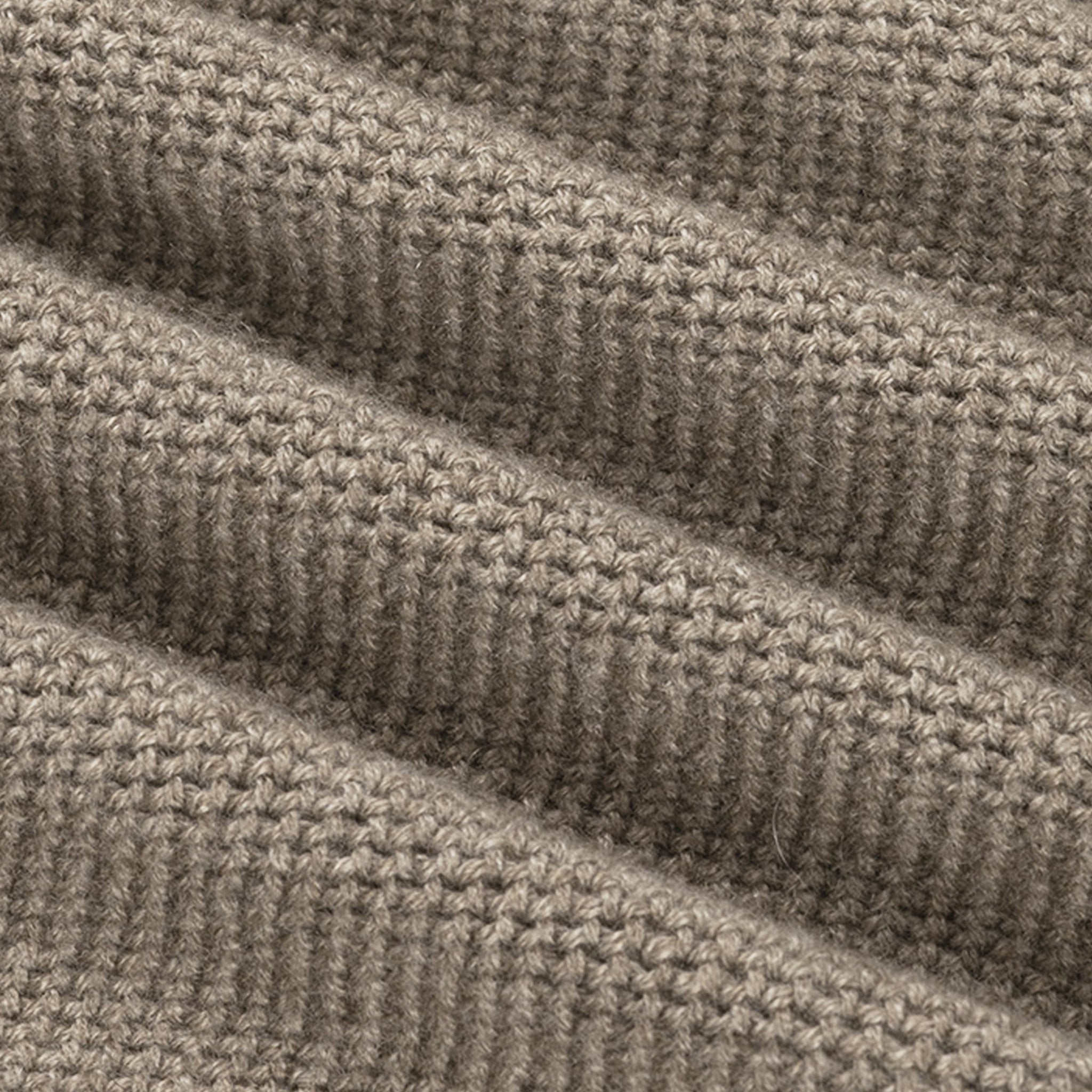Close-up of a textured beige fabric with a ribbed pattern