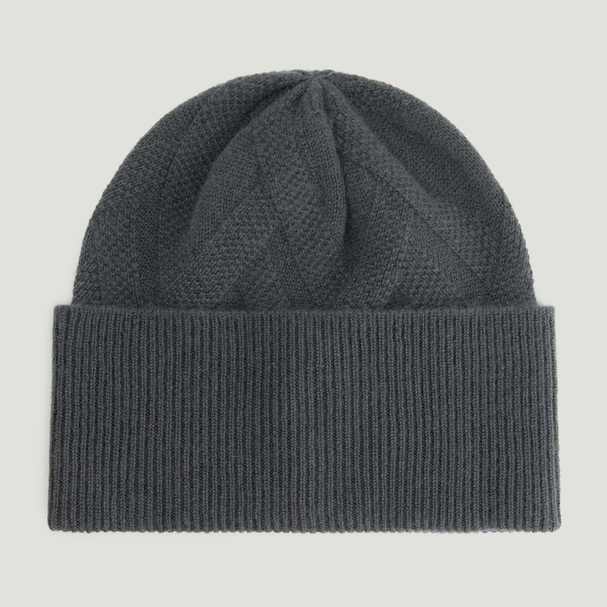Dark gray knit beanie on a light gray background 