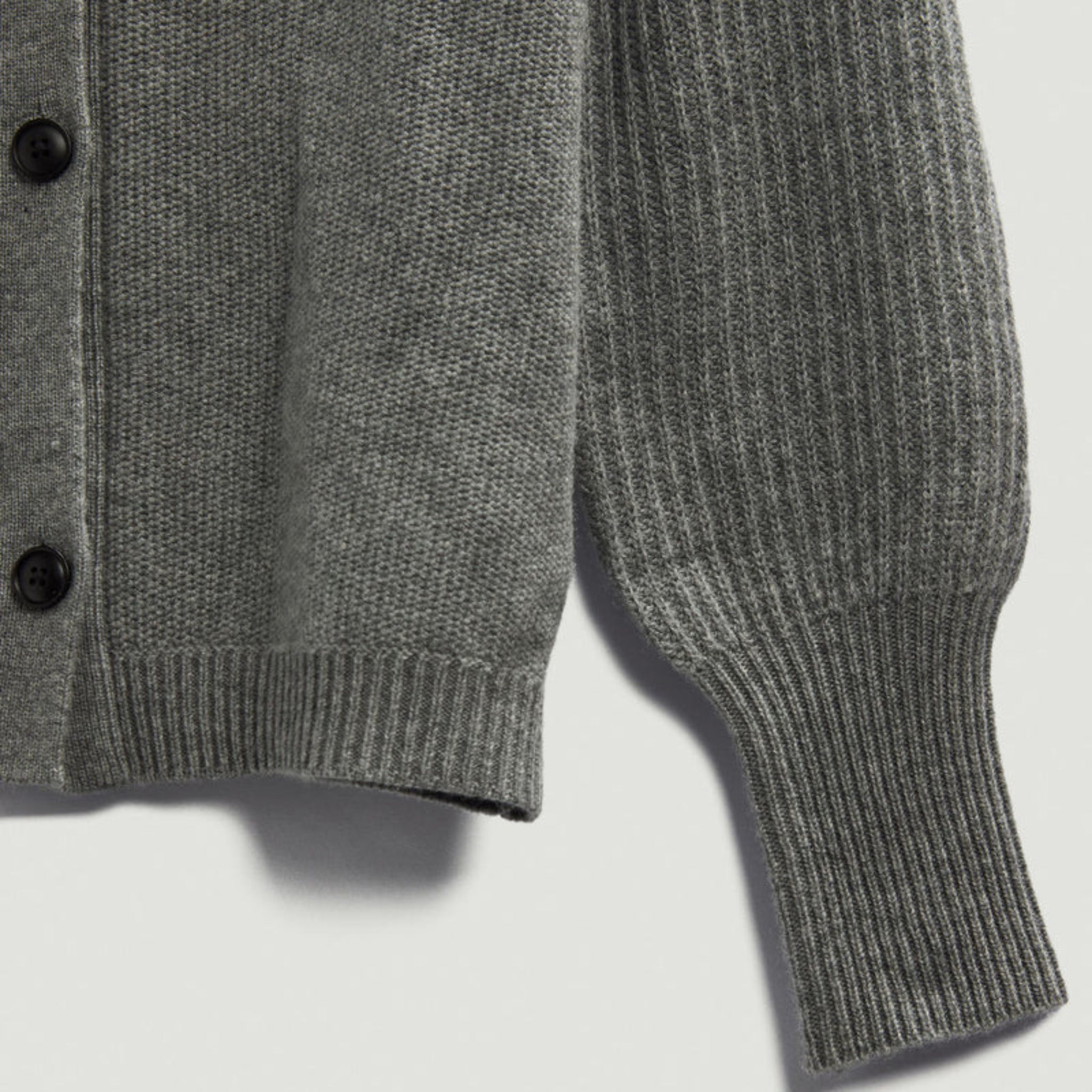 Gray knitted cardigan on a light gray background