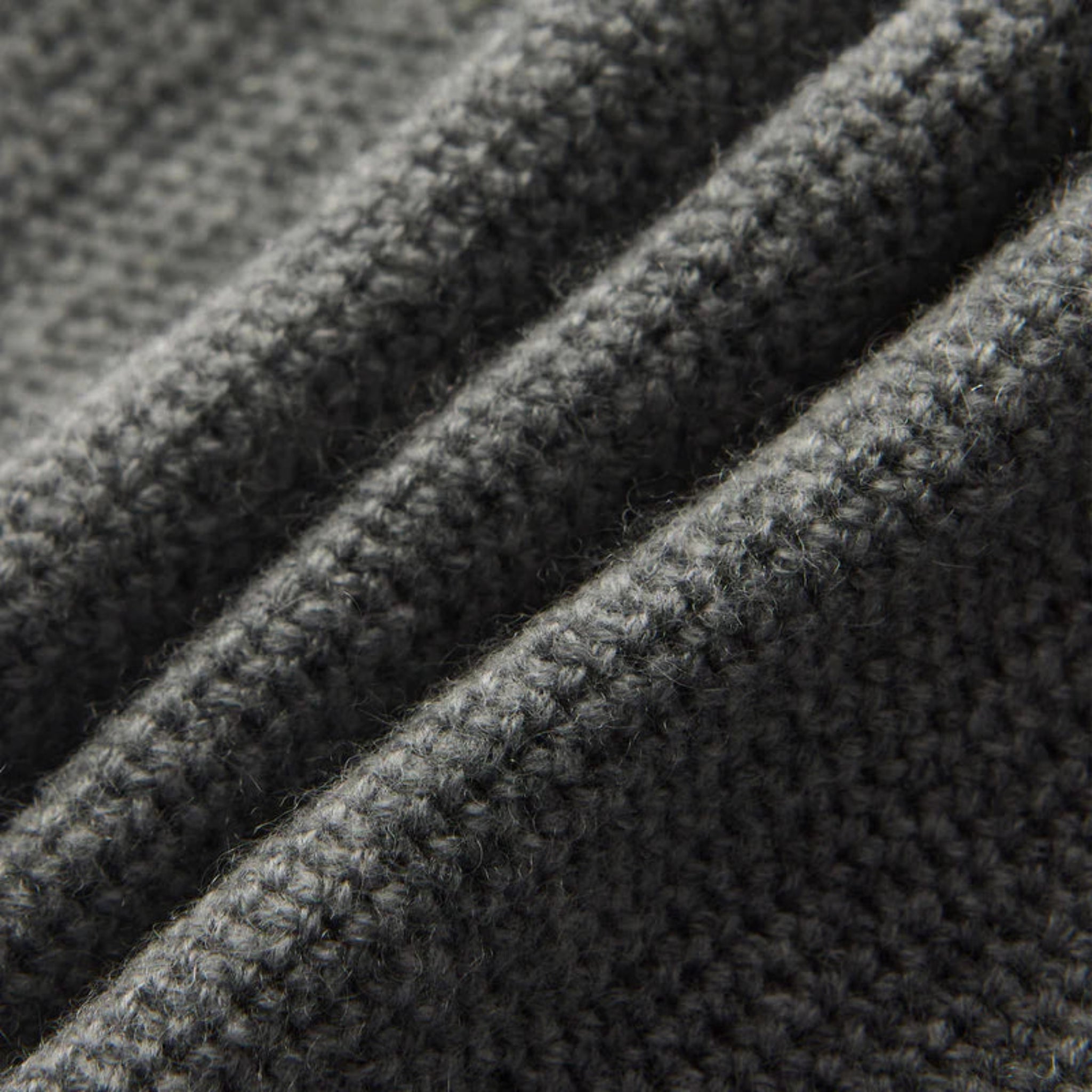 Close-up of textured dark gray fabric with a ribbed pattern