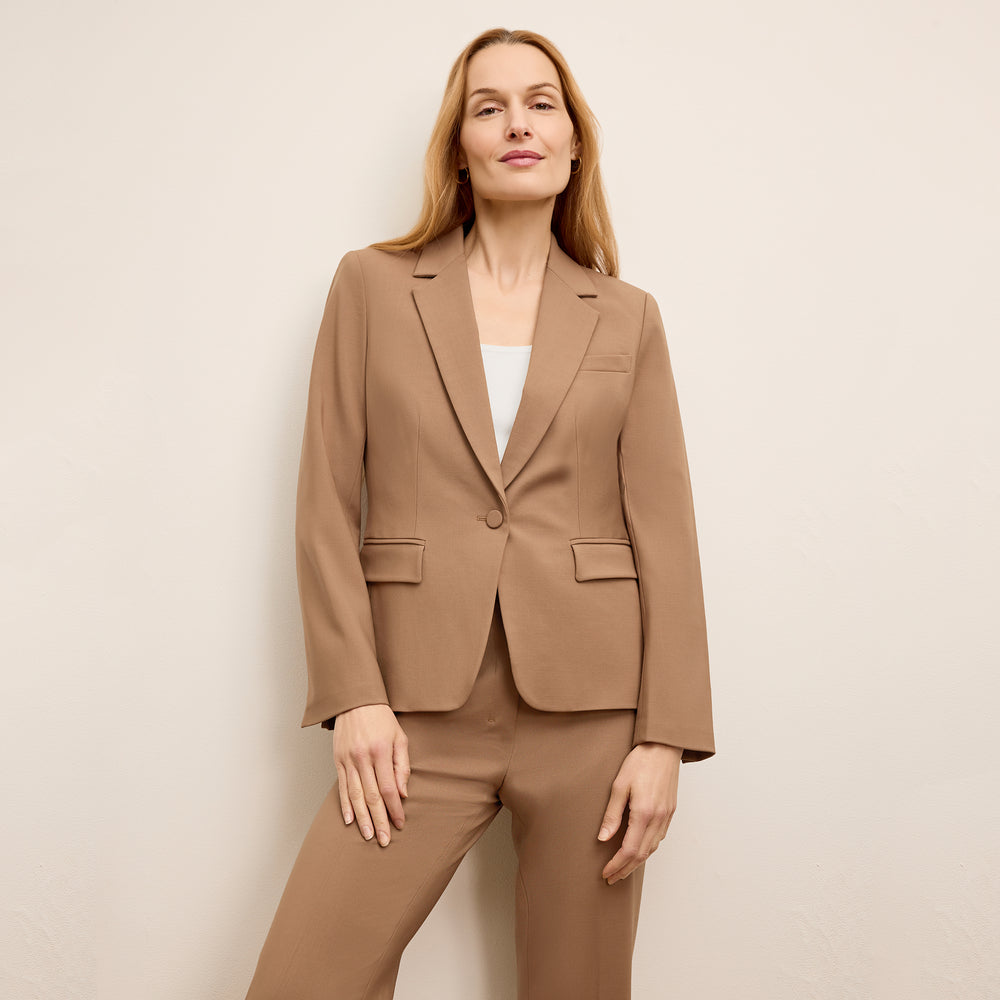 front image of a woman wearing the yasmine jacket in saddle