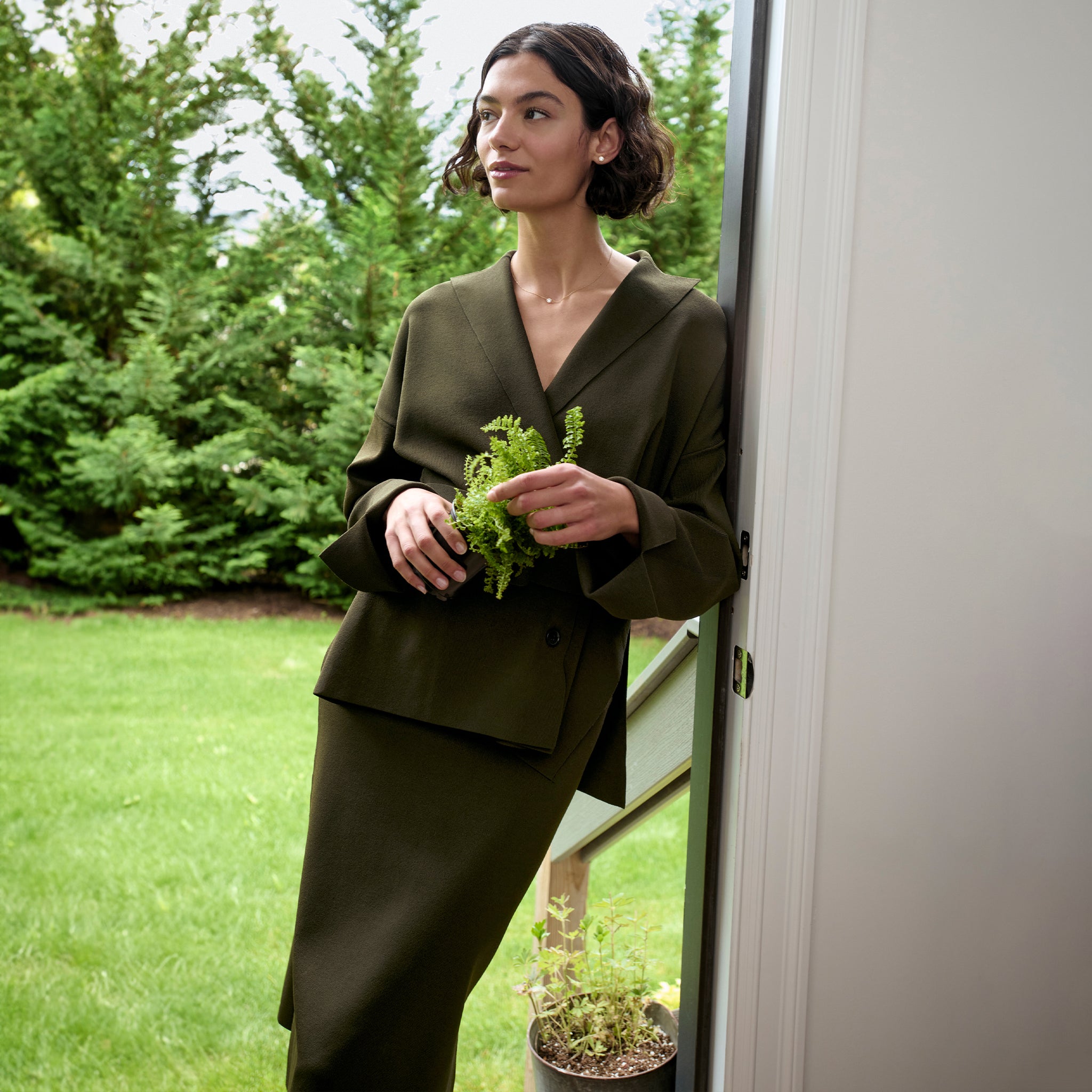 front image of a woman wearing the yuwei jardigan in dark elm