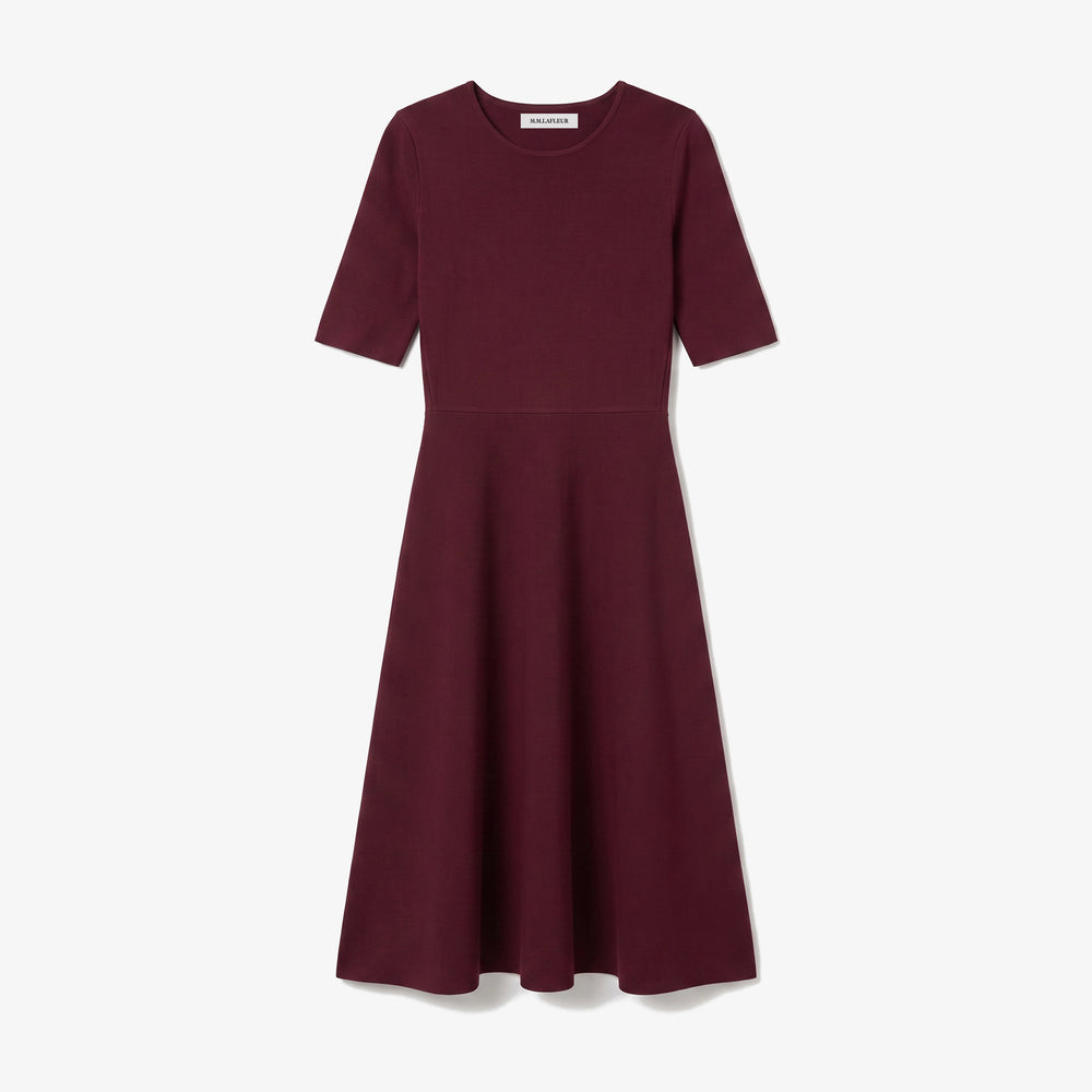 A short-sleeve A-line dress in deep burgundy, featuring a round neckline and a flared skirt, shown against a light gray background.