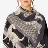 Image of a woman wearing a scarf with animals on it in black white and gray