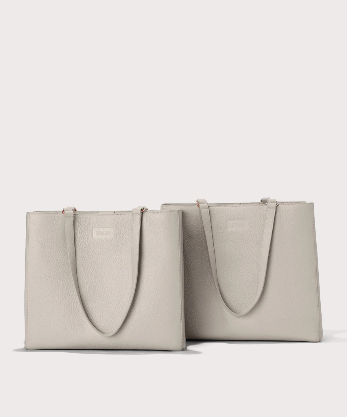 Two light gray tote bags on a white background