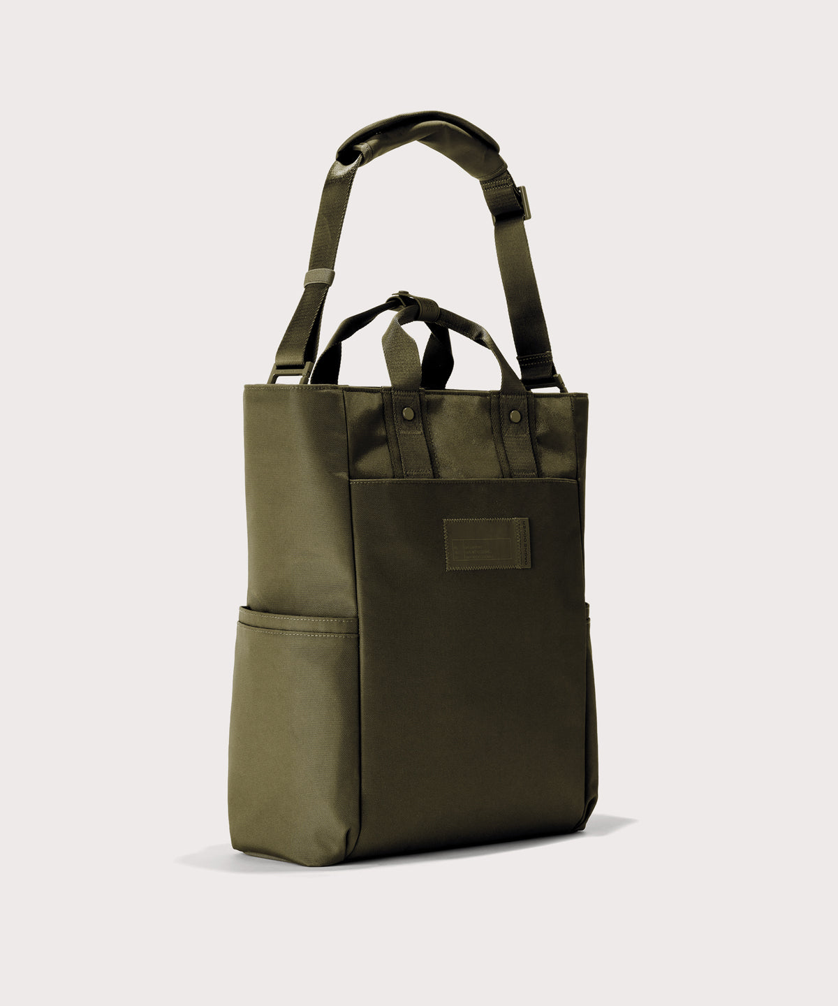 Green tote bag with a pocket on a light gray background