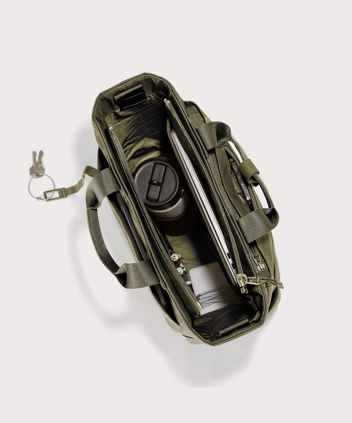 Green travel bag with compartments on a white background