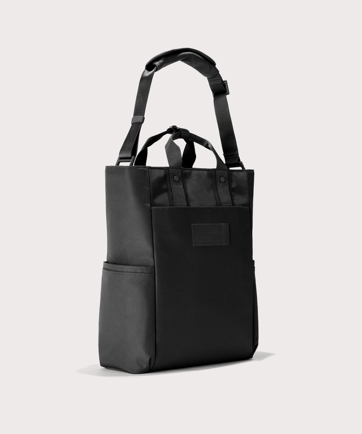 Black tote bag with a black pocket on a white background