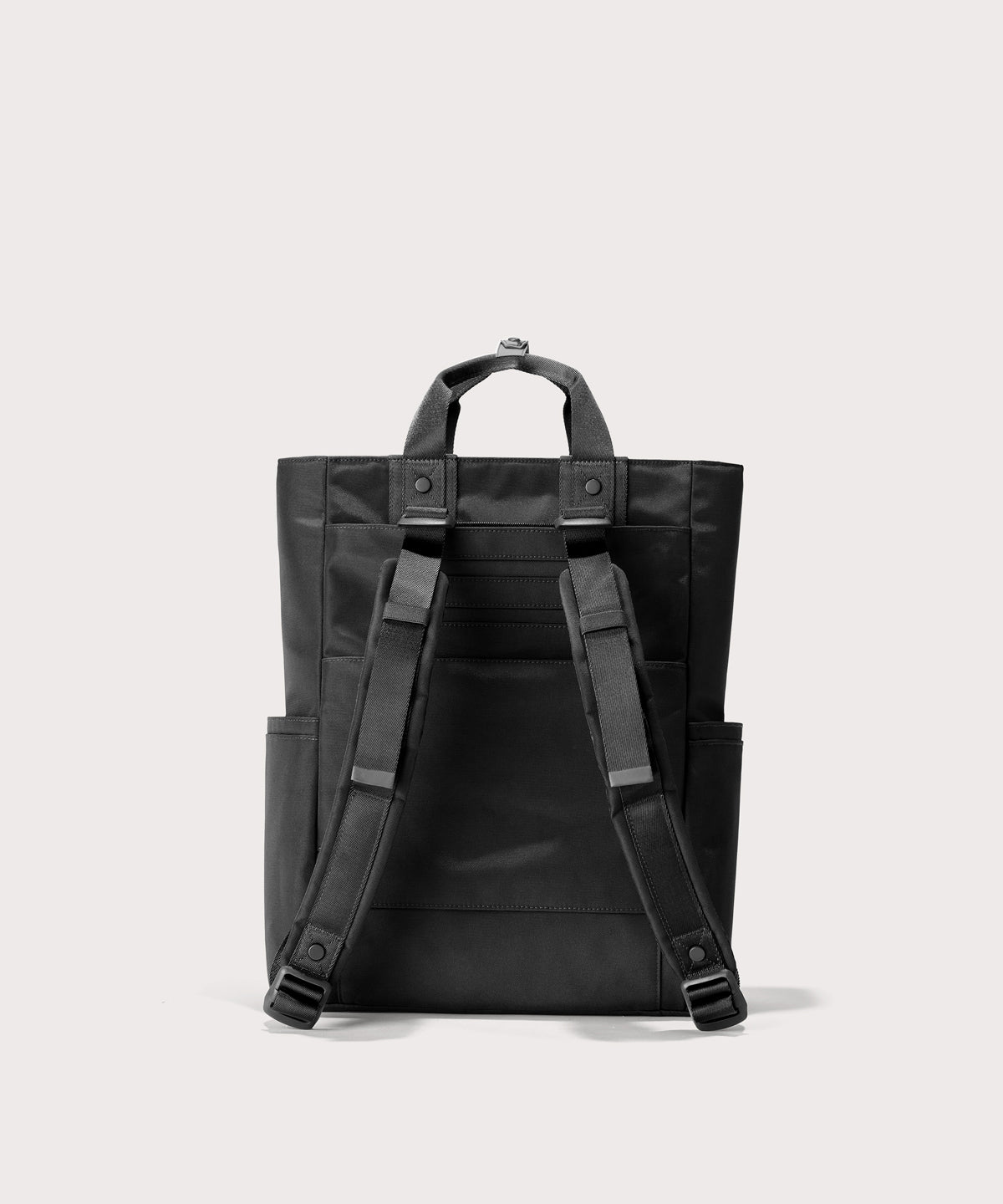 Black backpack with straps on a light gray background