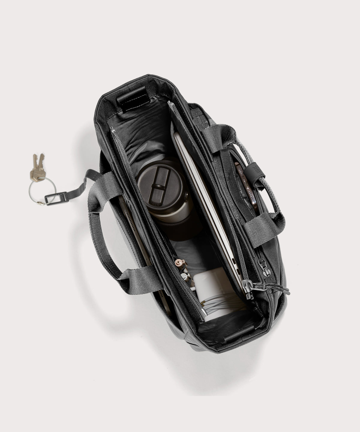 Black backpack with compartments on a white background