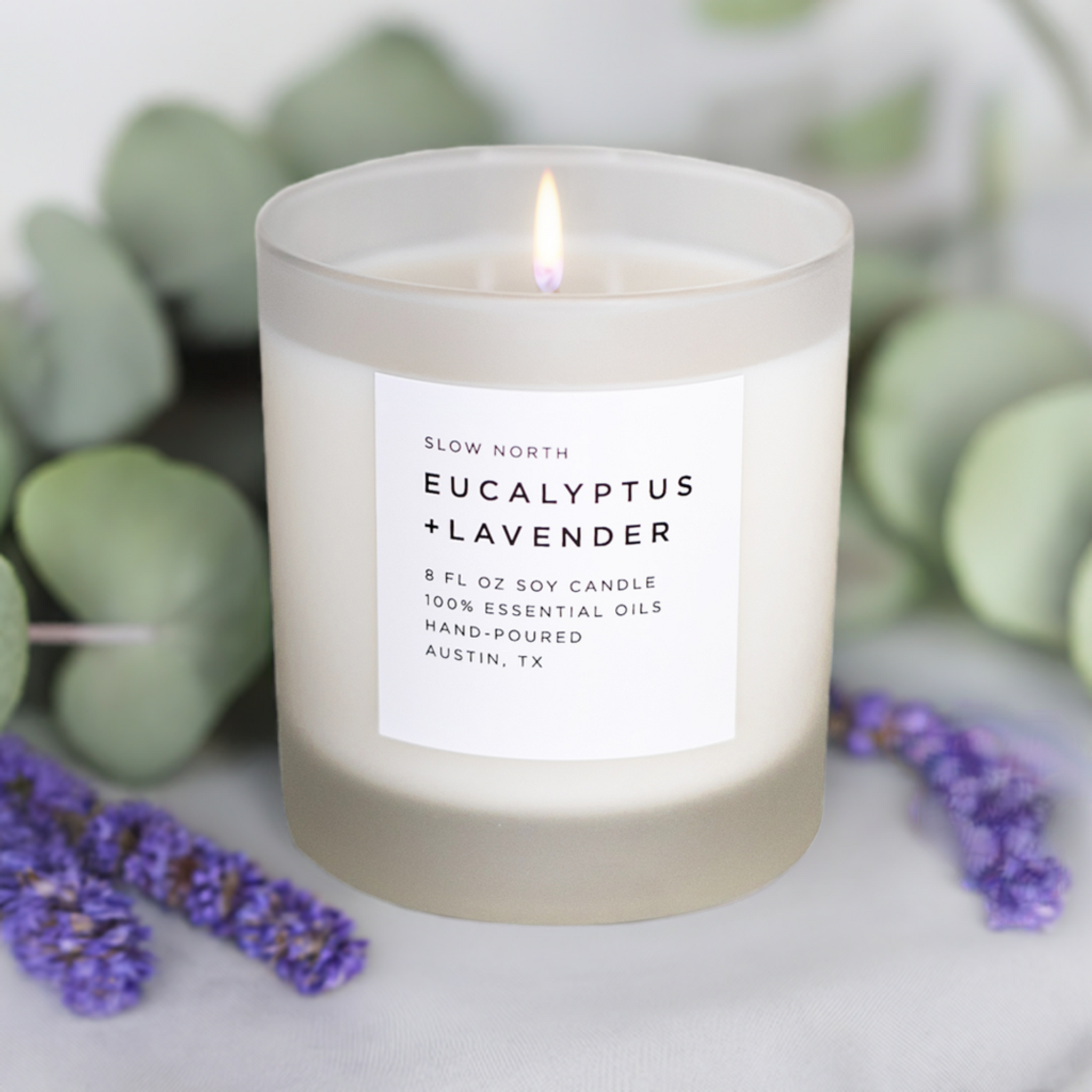 Scented candle labeled 'Eucalyptus + Lavender' with a label on a white background