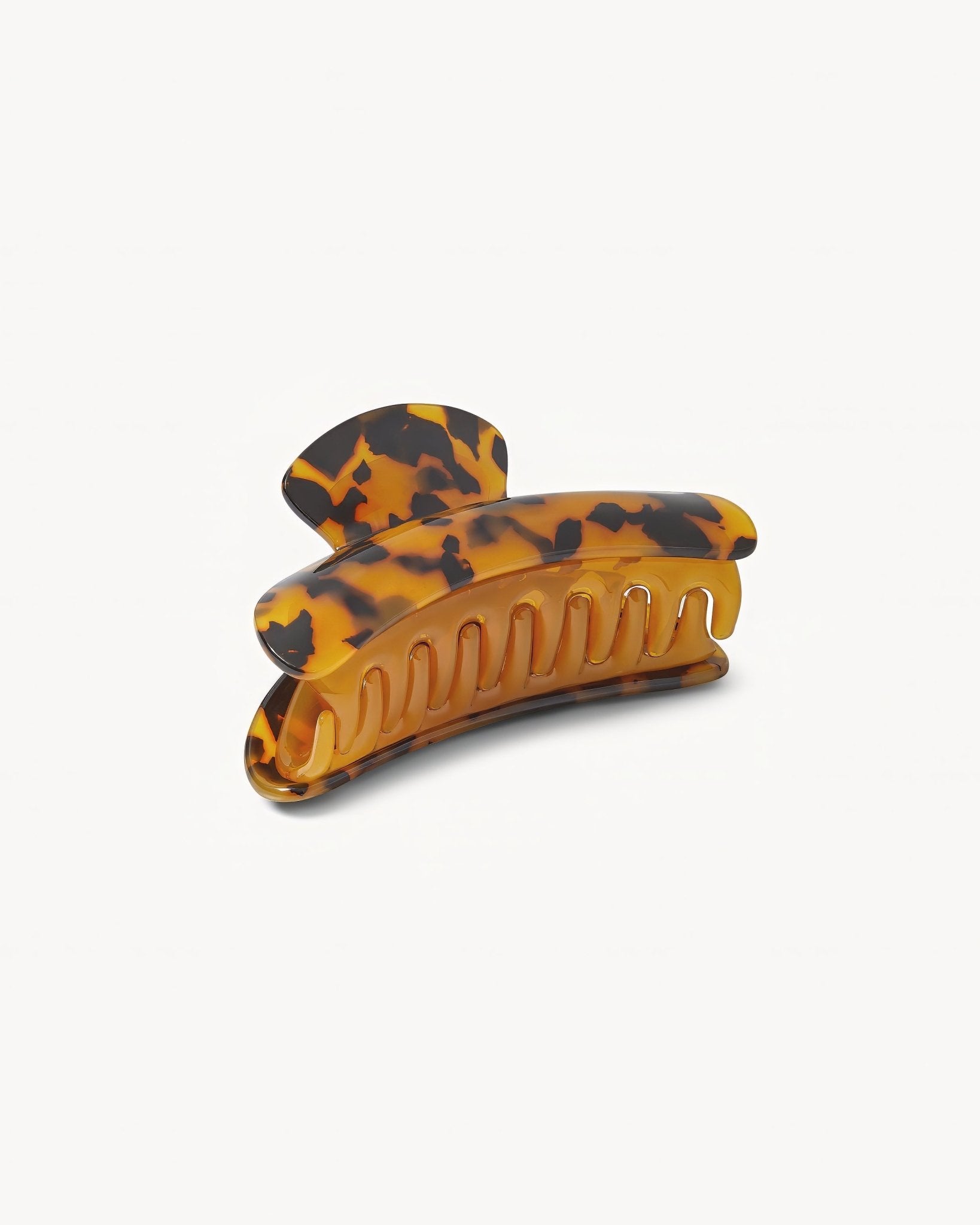 Tortoiseshell patterned hair clip on a white background