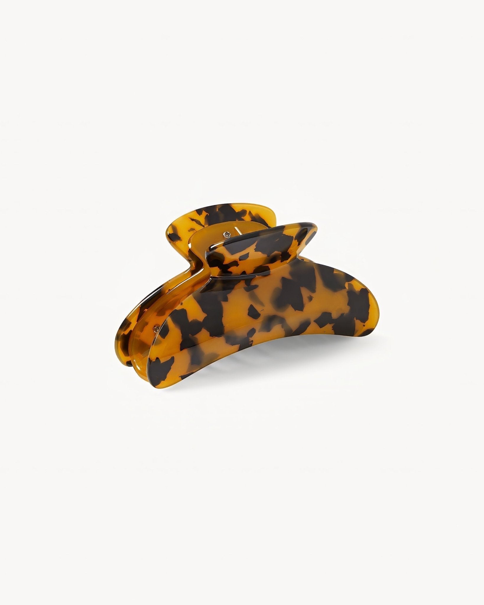 Tortoiseshell patterned hair clip on a white background
