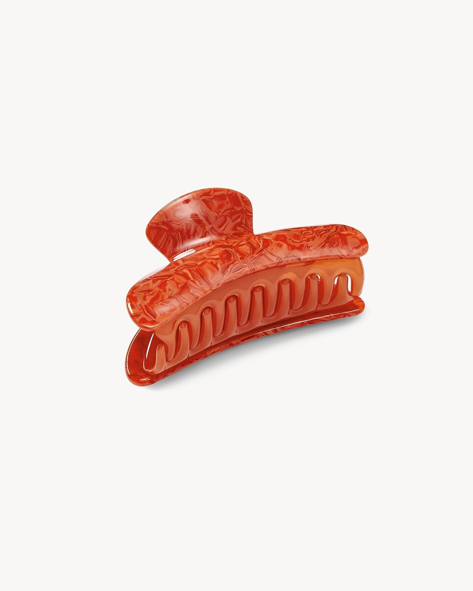 Decorative orange hair clip on a white background
