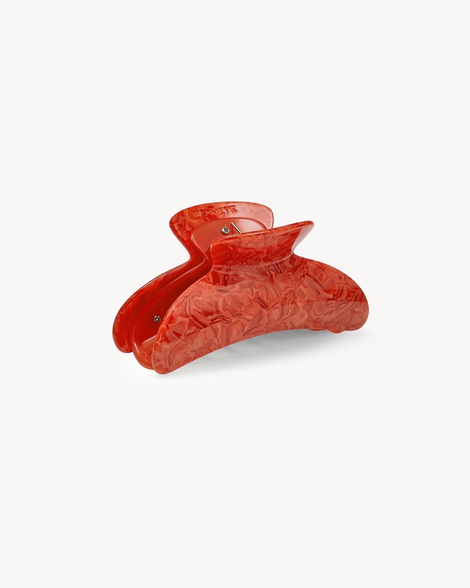 Red hair clip on a white background