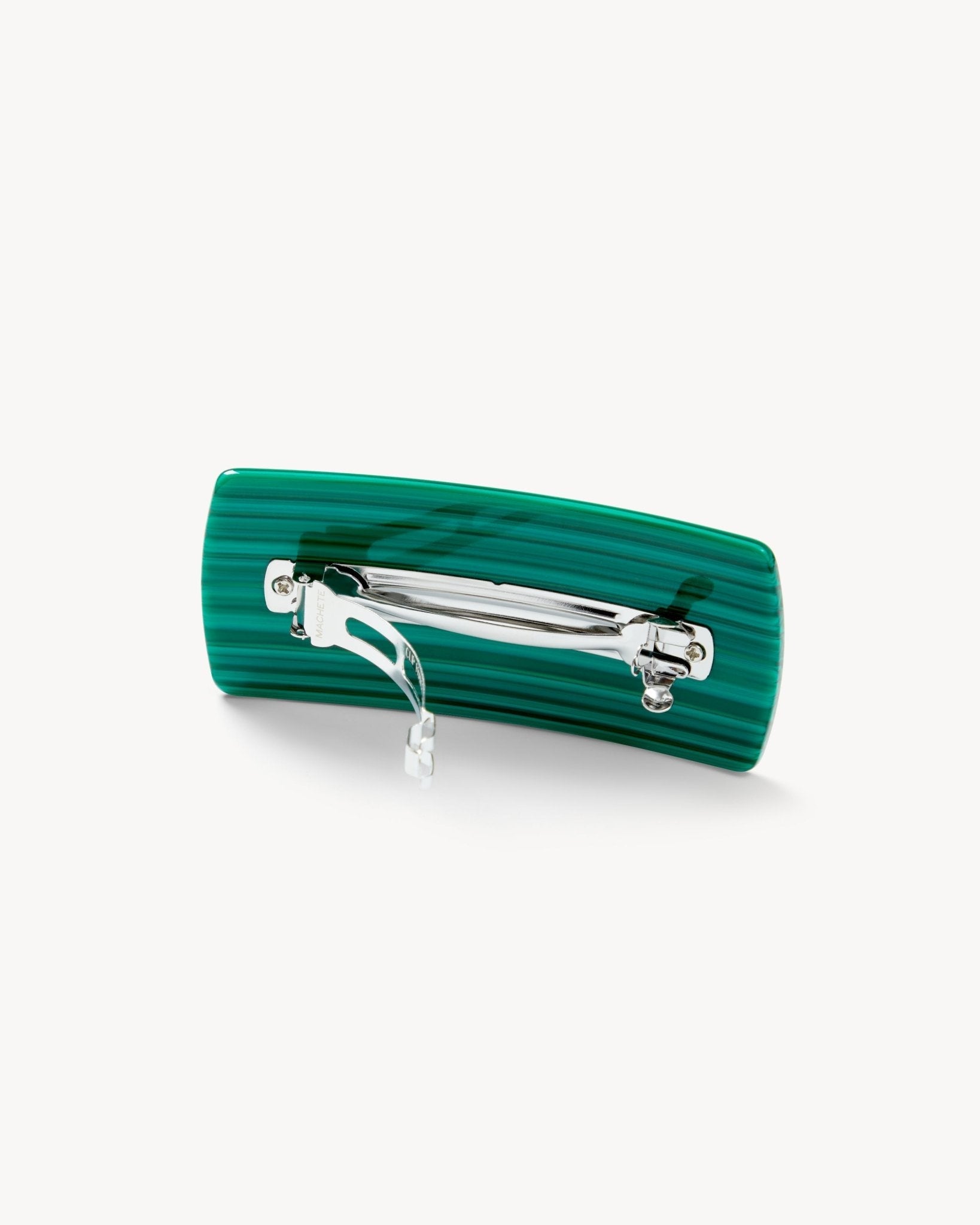 Green hair clip with silver clasp on a white background