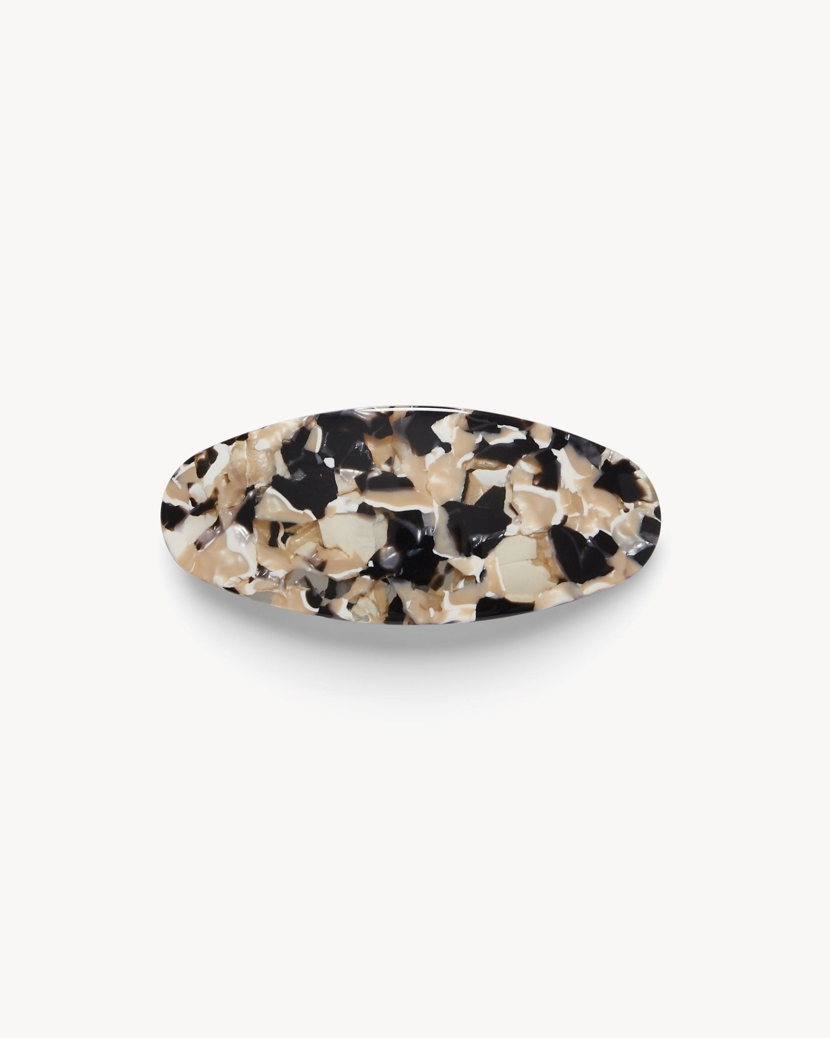 Oval hair clip with a tortoiseshell pattern on a white background 