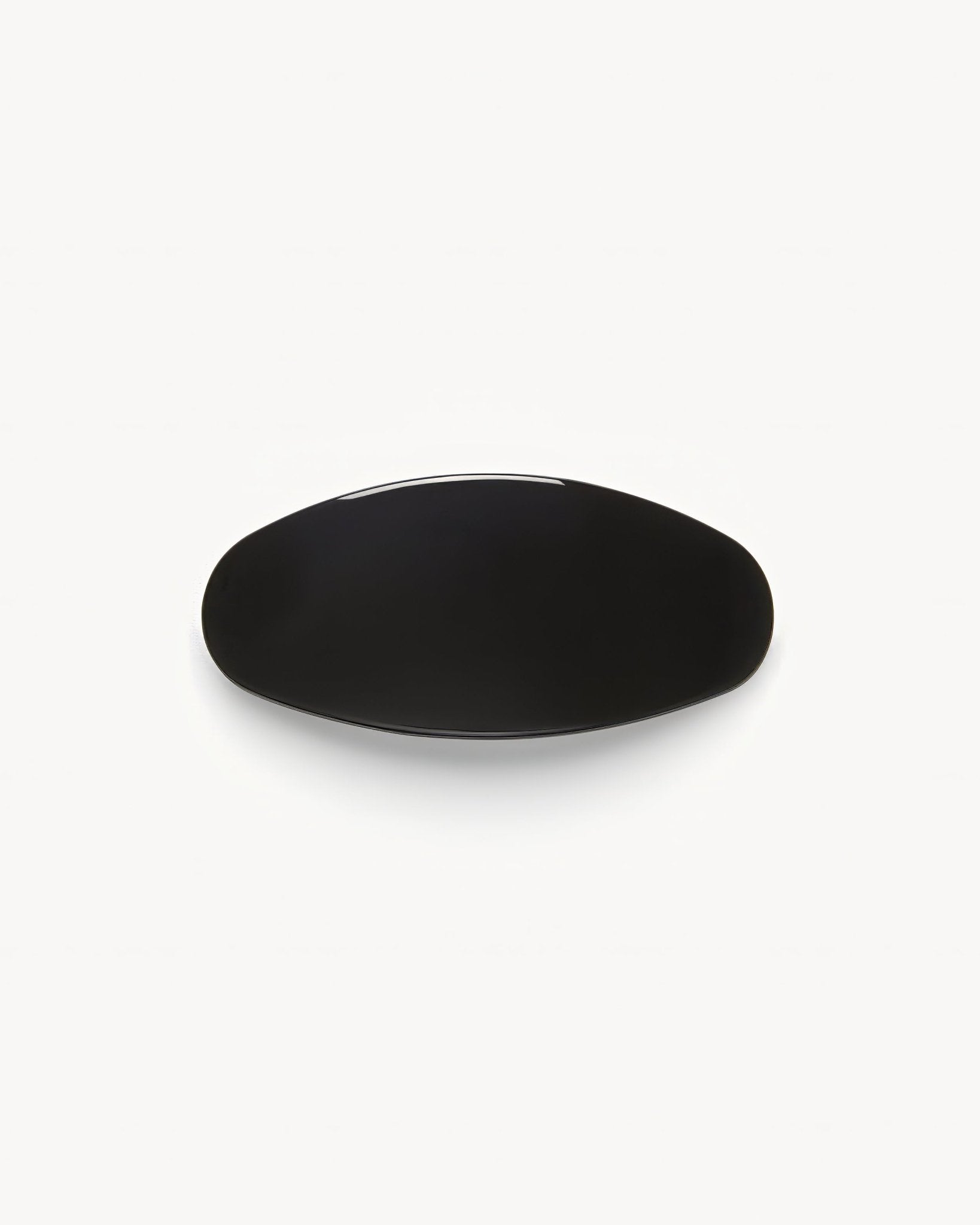 Black ceramic plate on a white background 