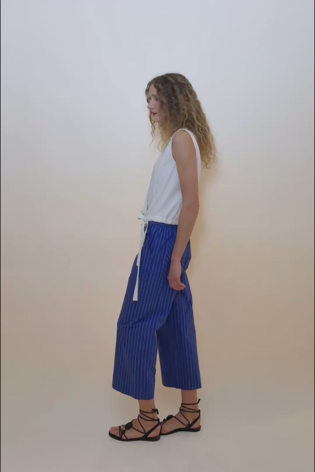 woman in white top and blue pants. 