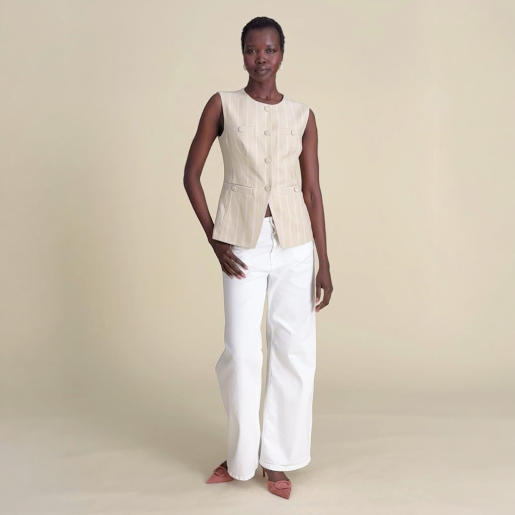 woman in aliza vest on beige background