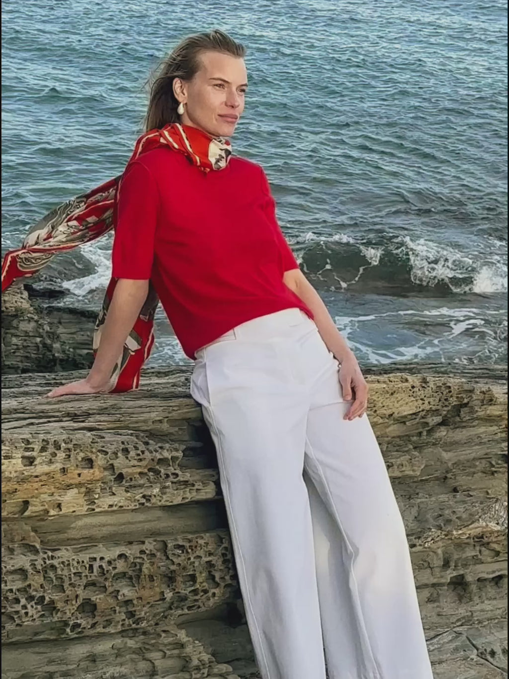 woman in red top and white jeans.