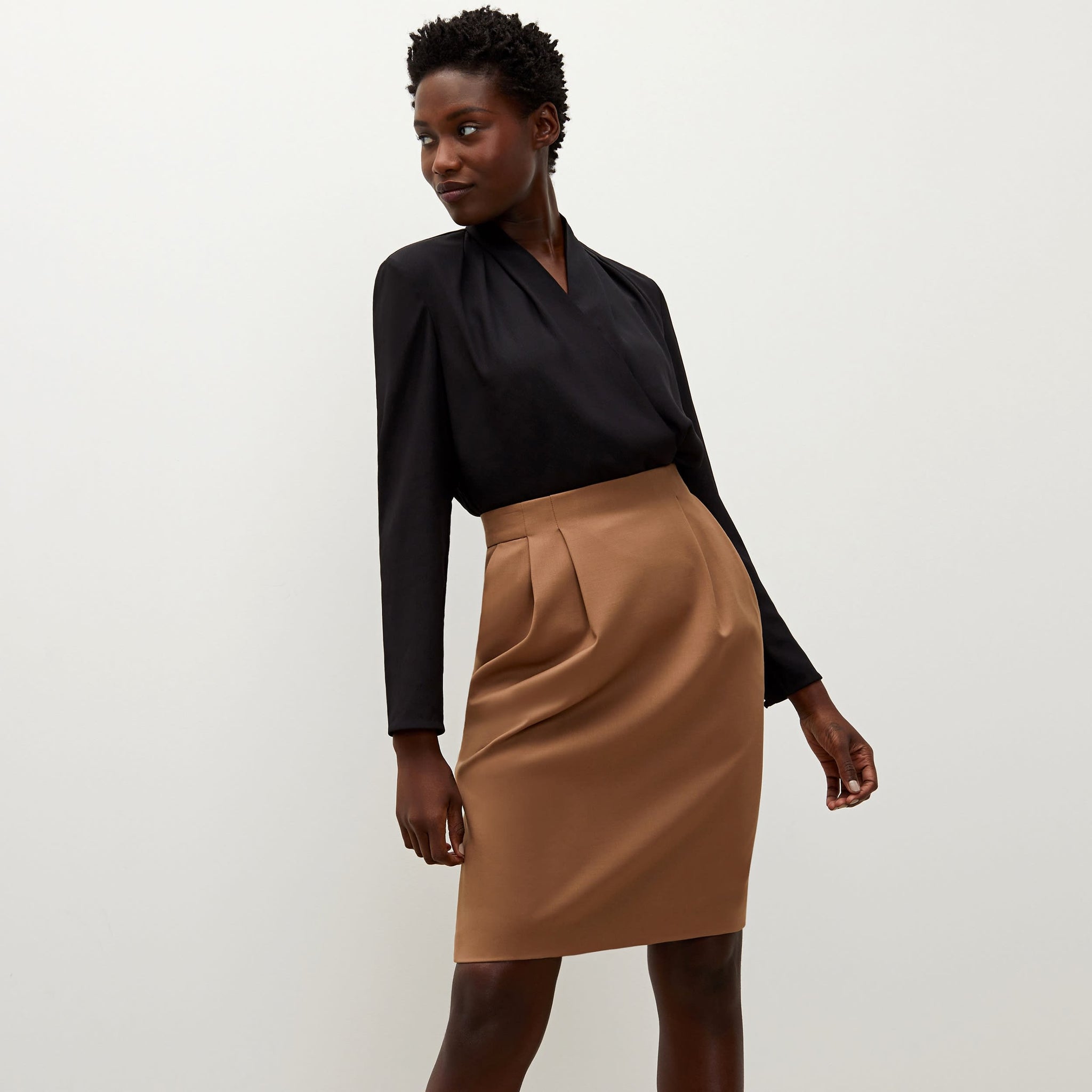 Front image of a woman standing wearing the antoinette top in black