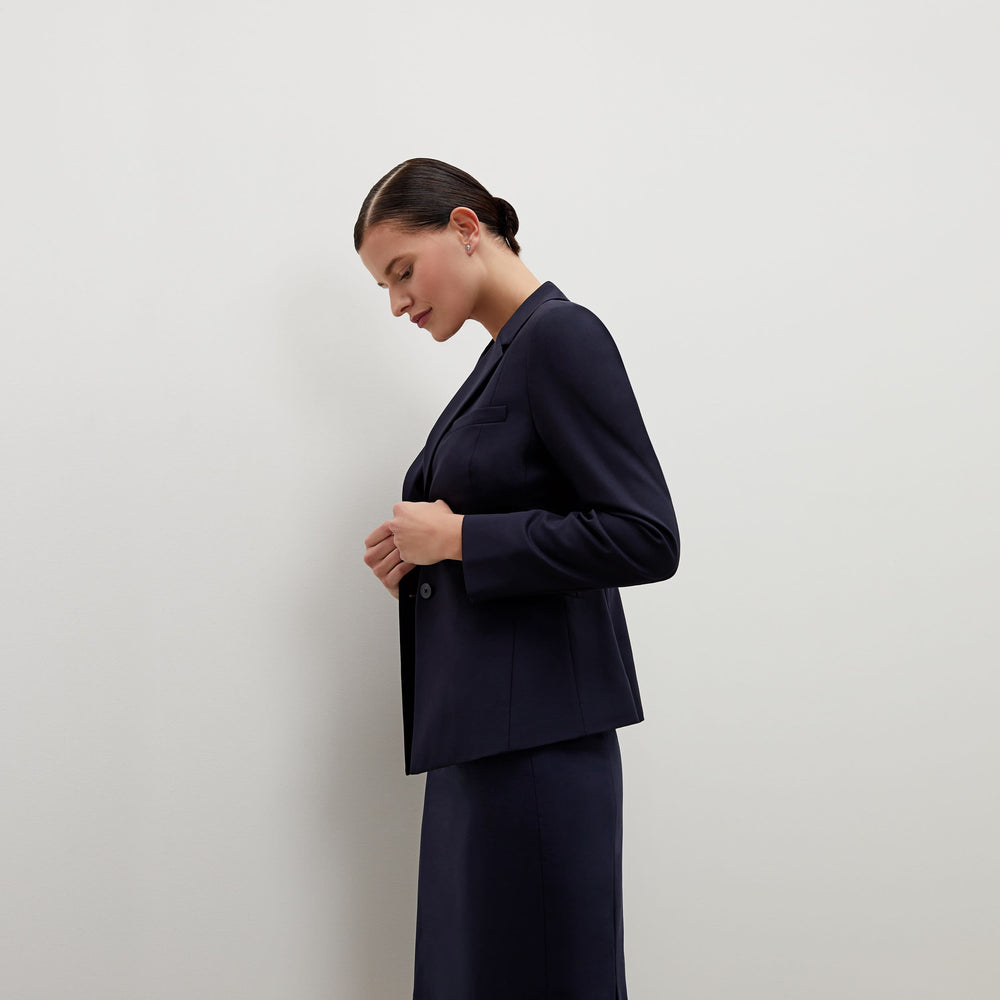 Side image of a woman standing wearing the Hoffman blazer in Galaxy Blue