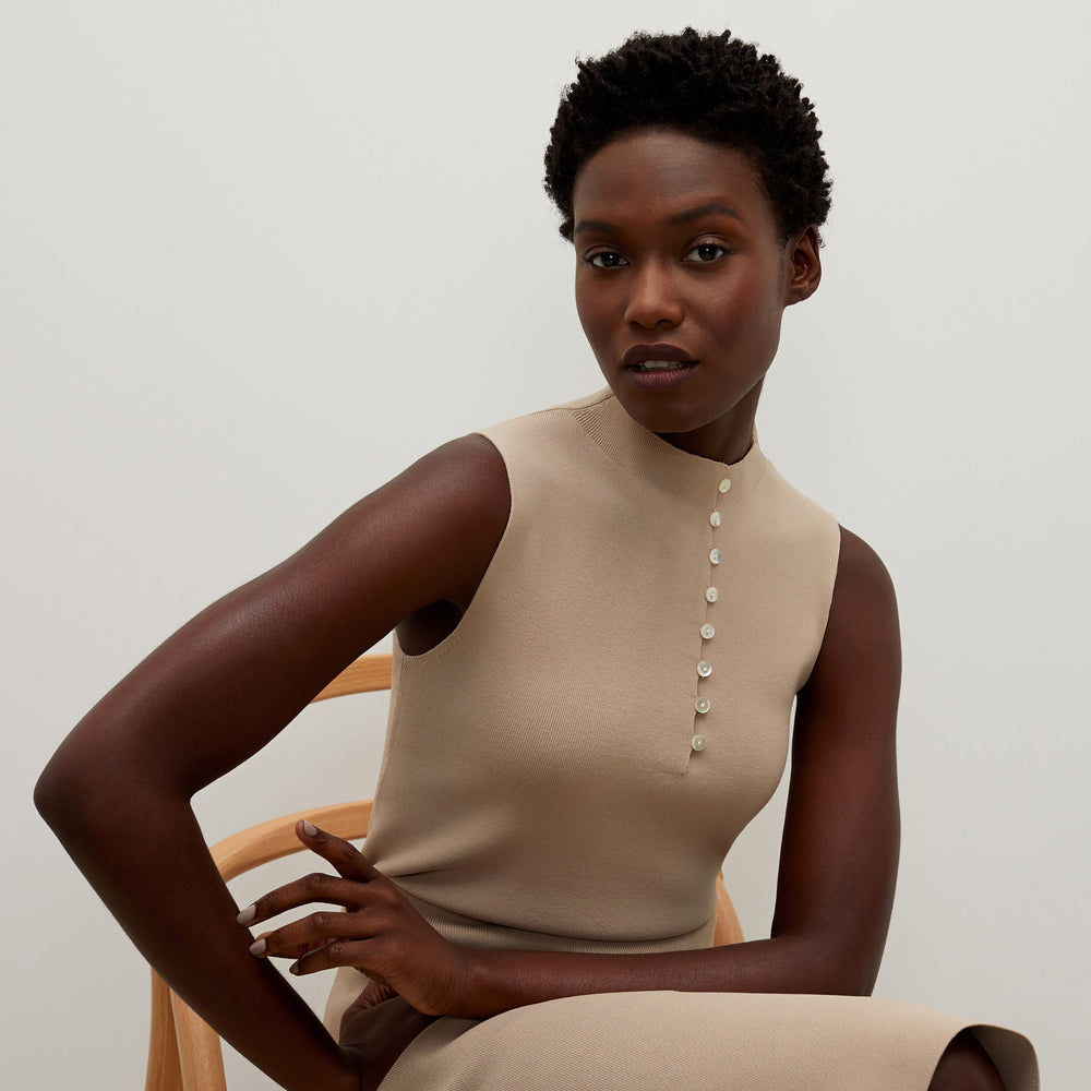 Detail image of a woman standing wearing the Malki top in latte