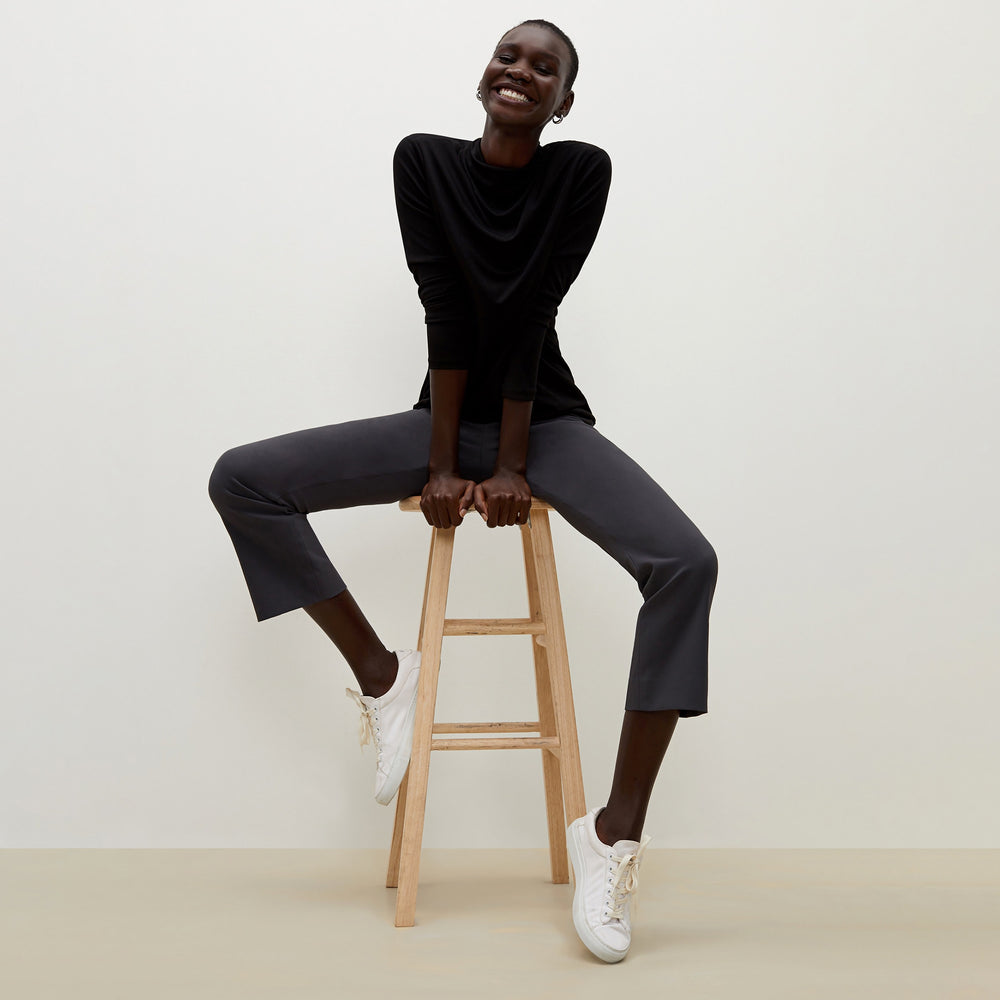 Side image of a woman standing wearing the Oshima pant in Monsoon