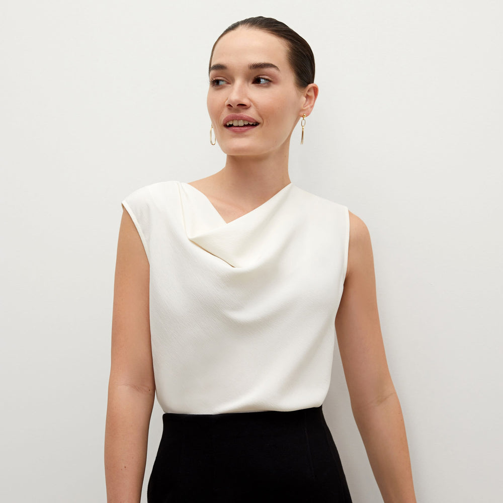 Side image of a woman standing wearing the Rowling Top in alabaster