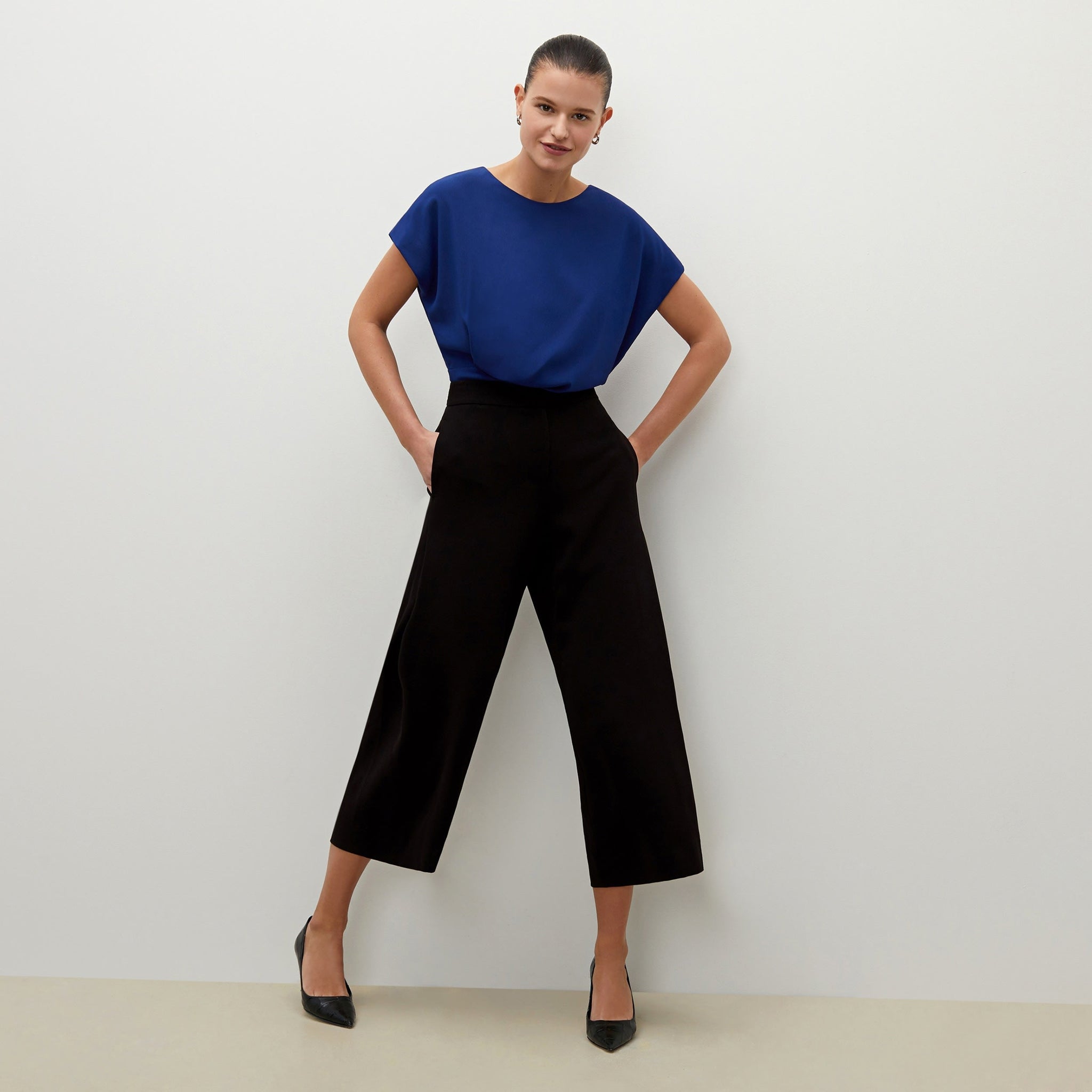 Front image of a woman standing wearing the Zhou culotte in black