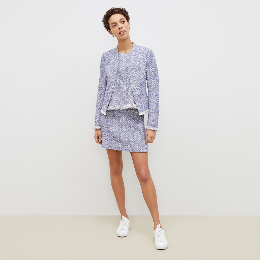 Front image of a woman standing wearing the flaka top in cotton boucle in lapis / ivory