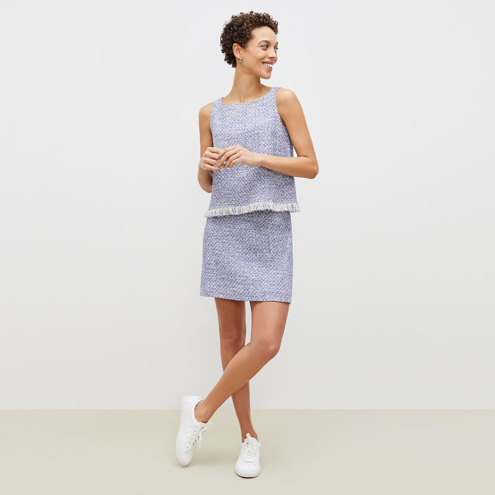 Front image of a woman standing wearing the flaka top in cotton boucle in lapis / ivory