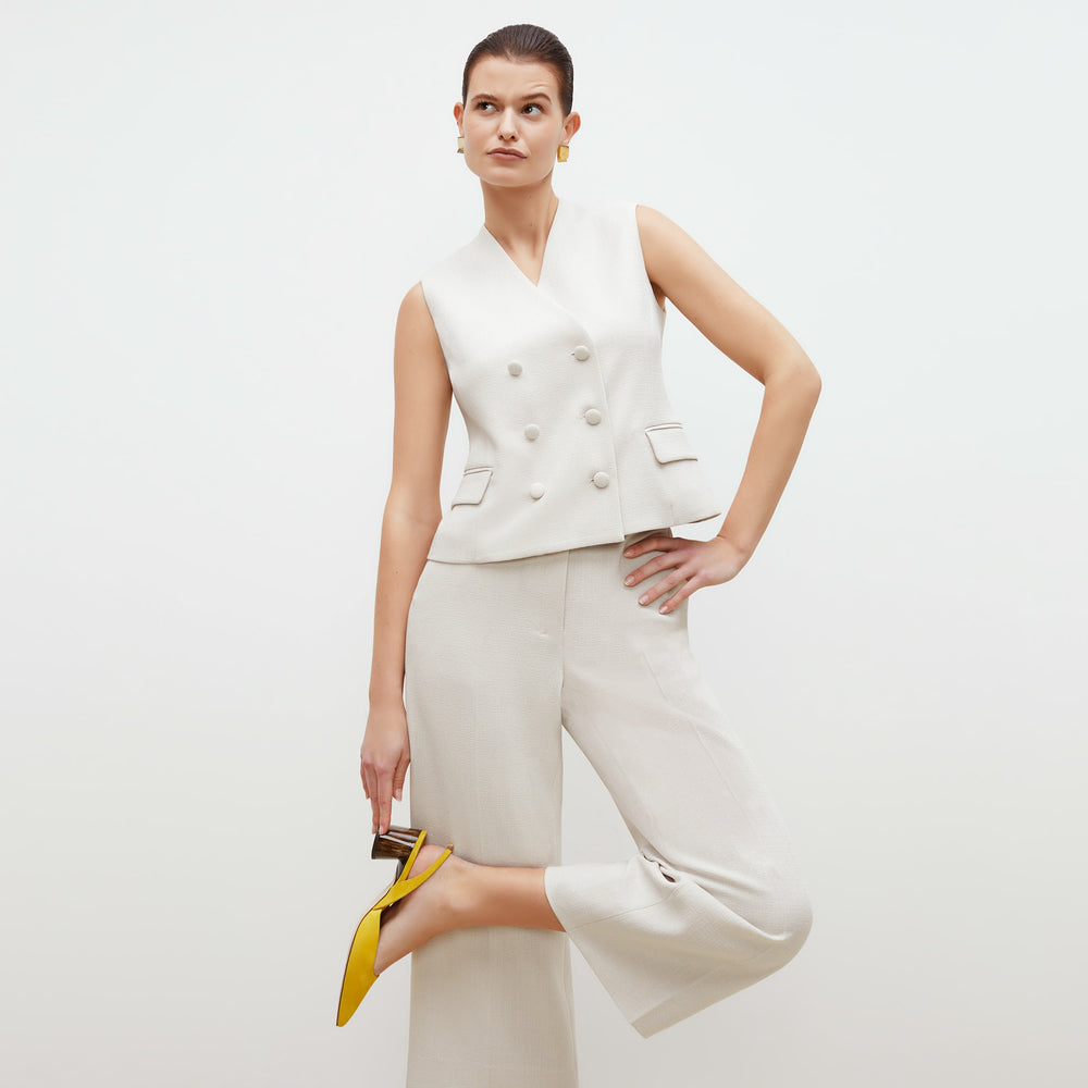 Front image of a woman standing wearing the willow vest in textured suiting in magnolia