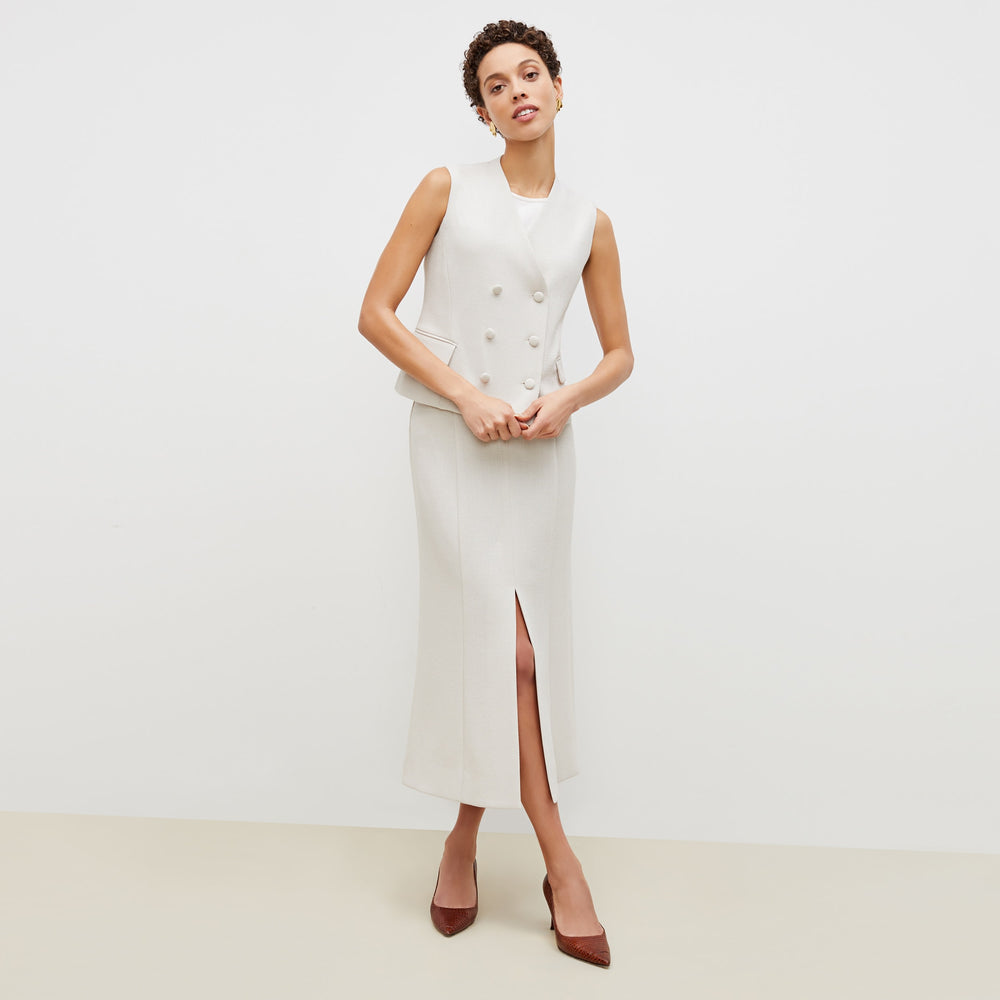 Front image of a woman standing wearing the willow vest in textured suiting in magnolia