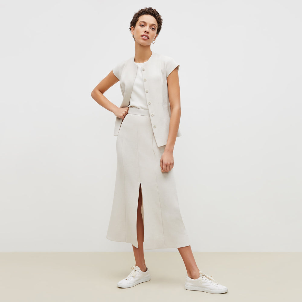 Front image of a woman standing wearing the lulu jacket in textured suiting in magnolia