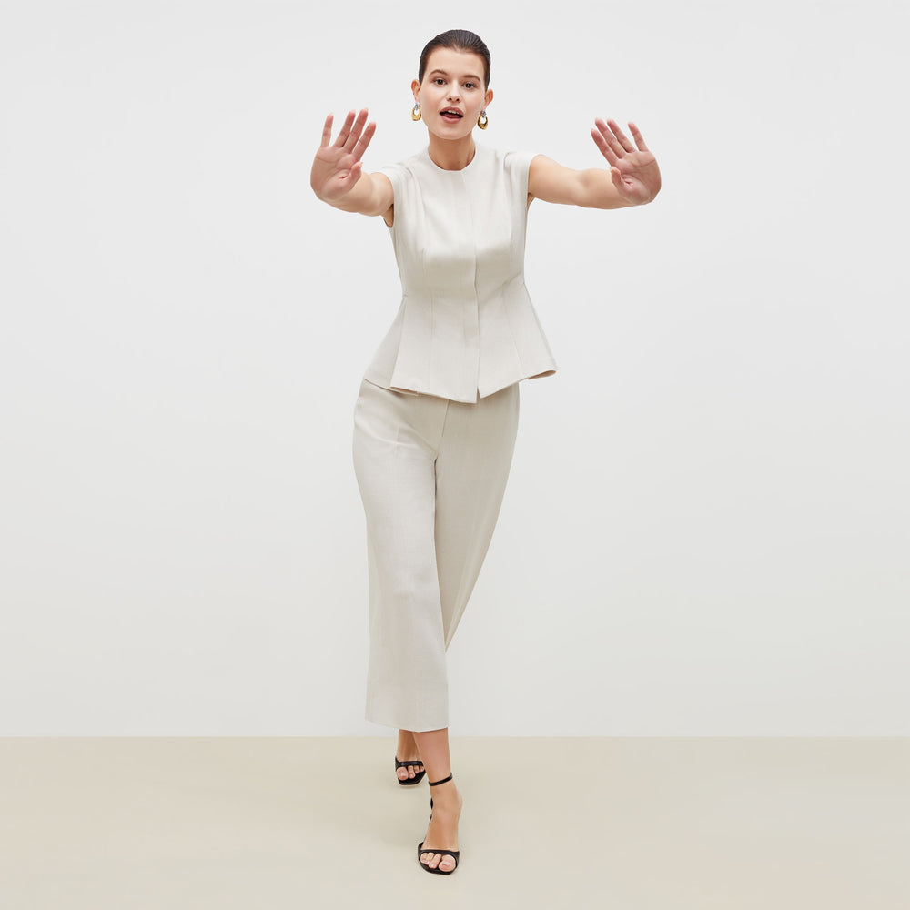 Front image of a woman standing wearing the lulu jacket in textured suiting in magnolia