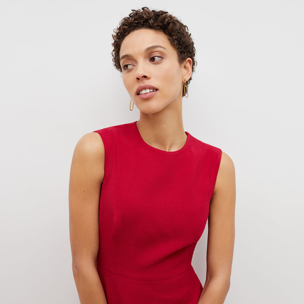 Detail image of a woman standing wearing the jane dress in staccato in hibiscus