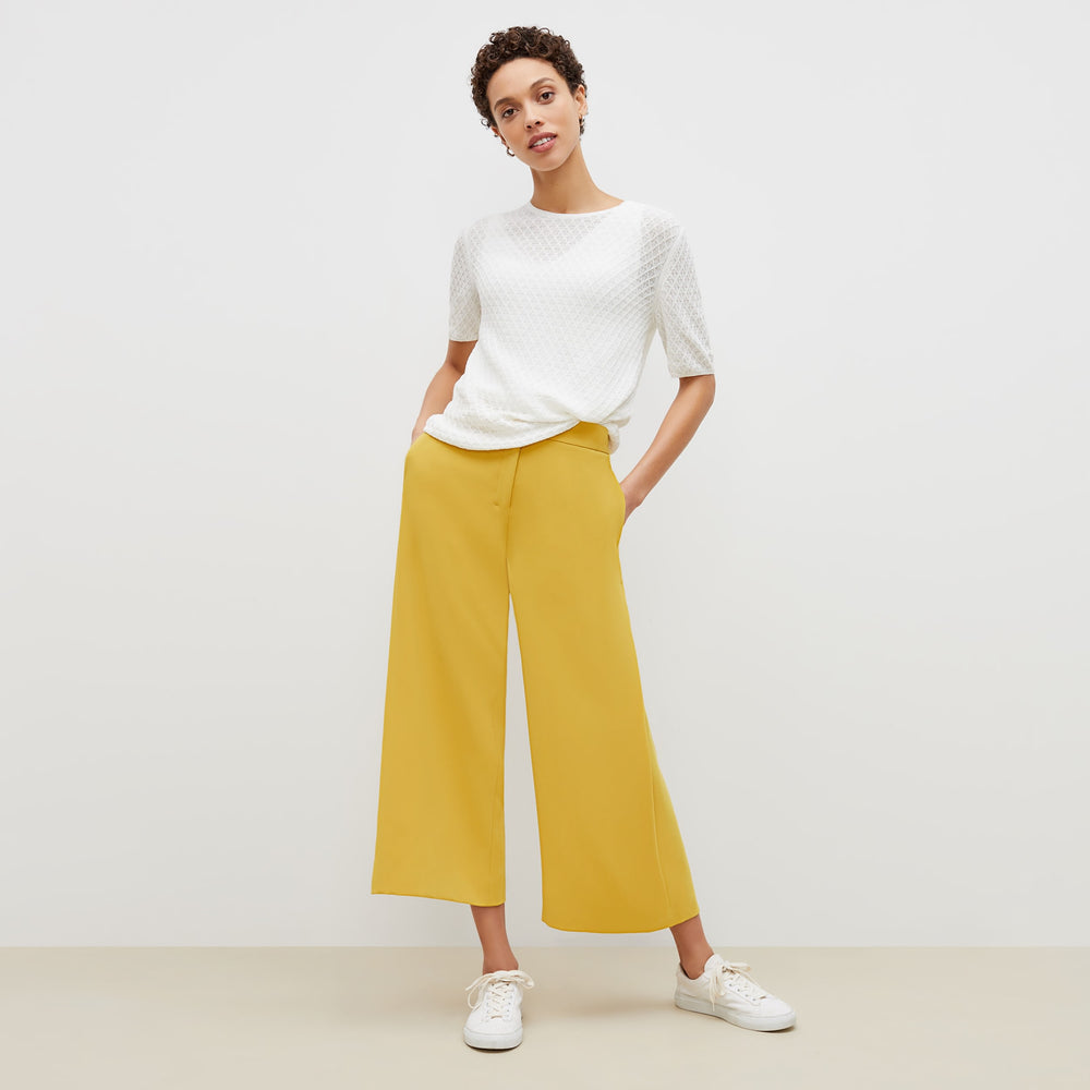 Front image of a woman standing wearing the natalie top in ivory