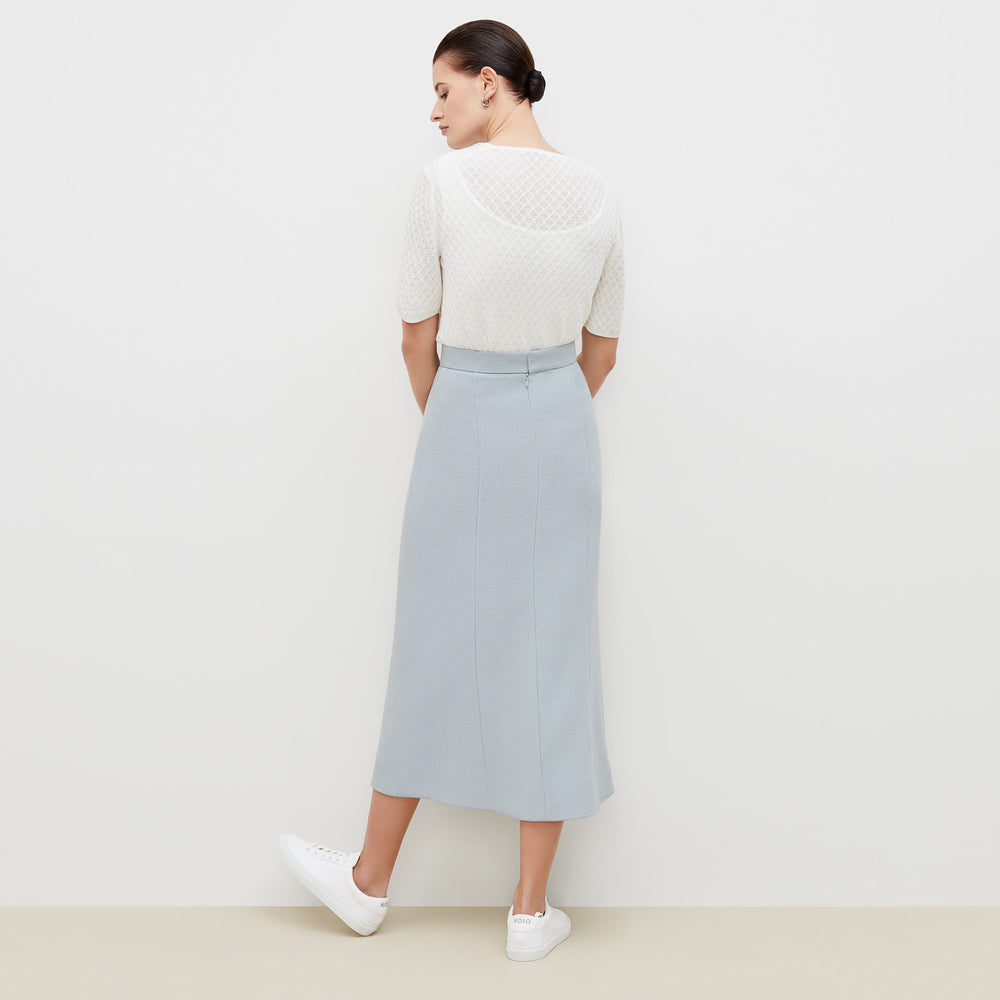 Back image of a woman standing wearing the natalie top in ivory