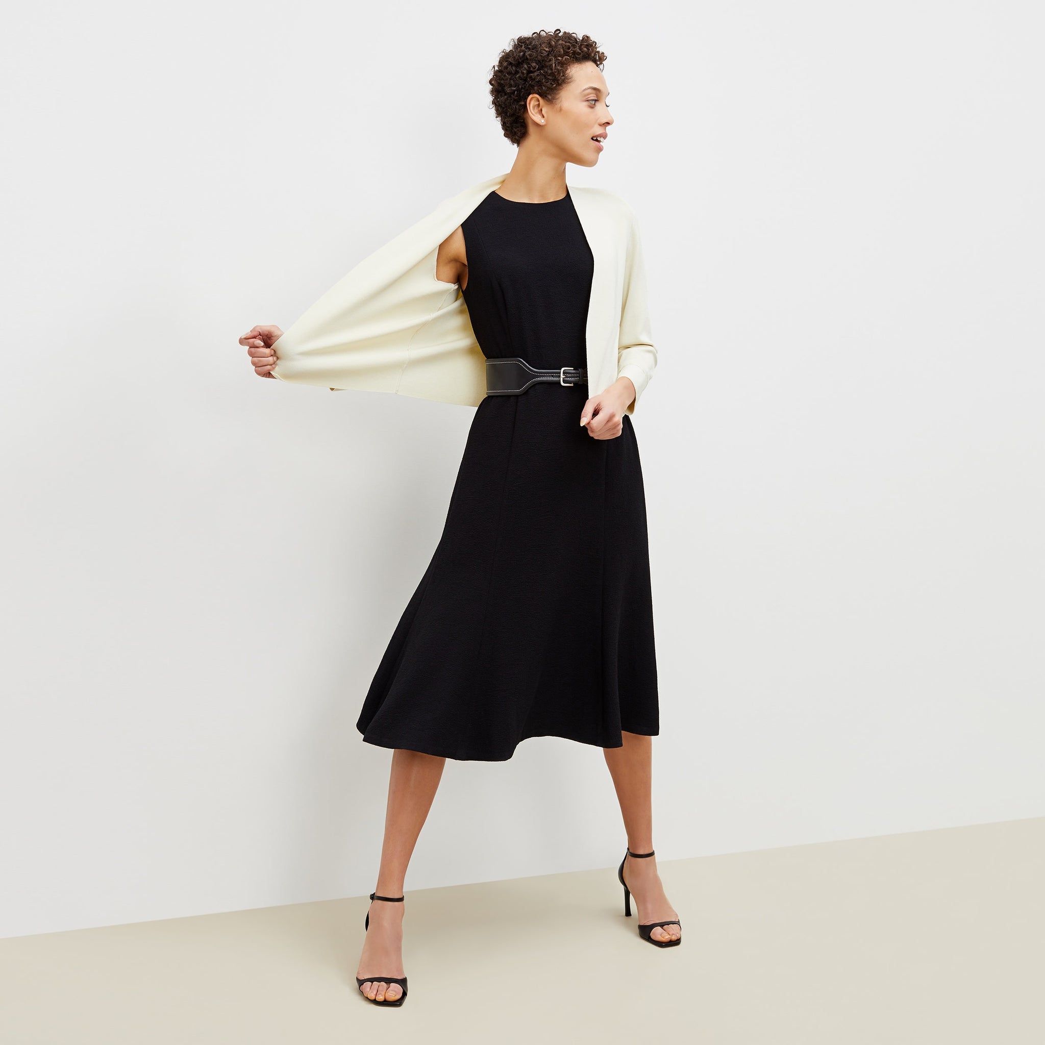 Front image of a woman standing wearing the sant ambroeus jardigan in ivory