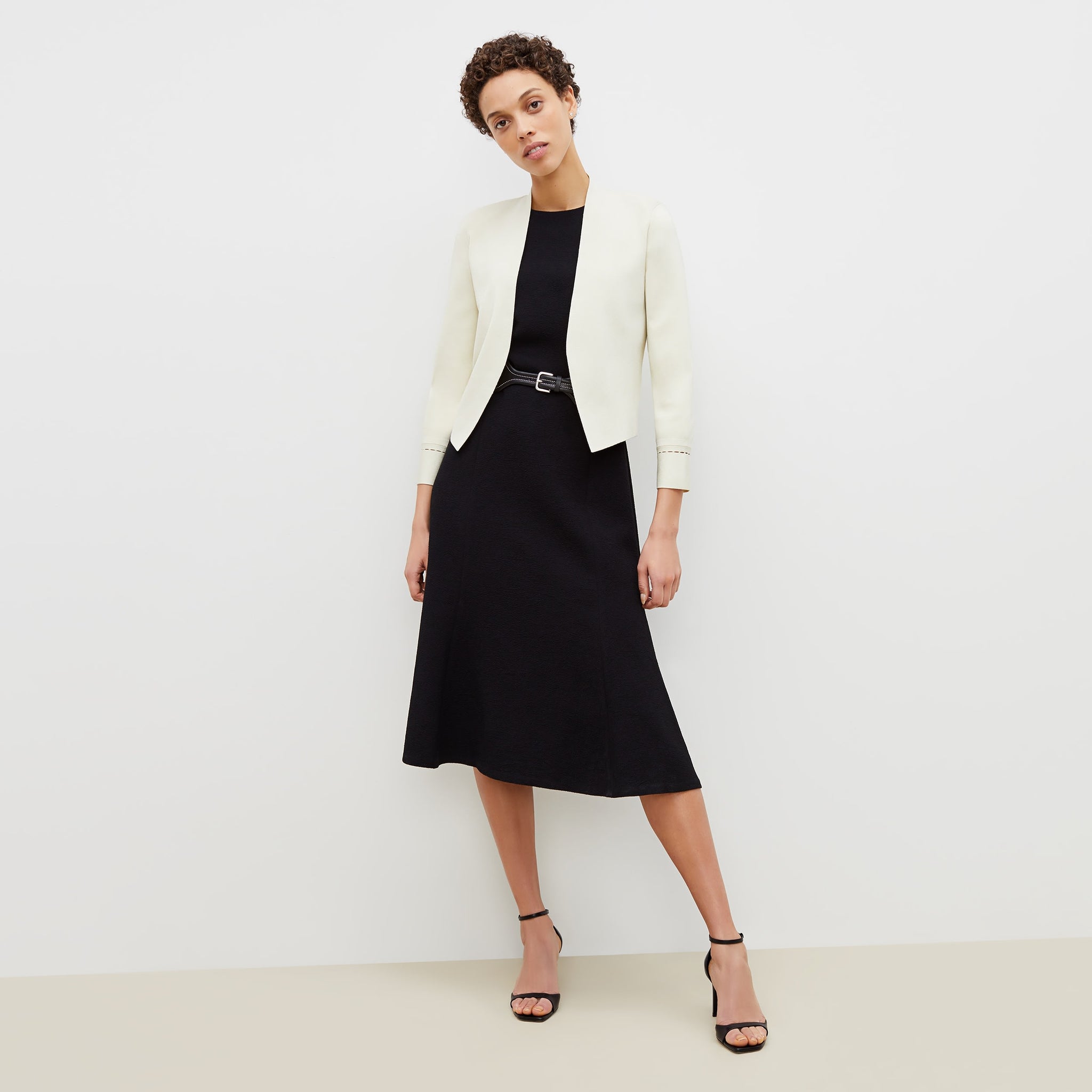 Front image of a woman standing wearing the sant ambroeus jardigan in ivory 