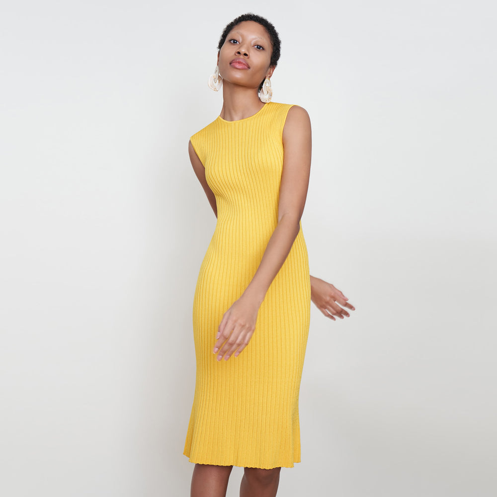 Front image of a woman standing wearing the dylan dress in tuscan yellow