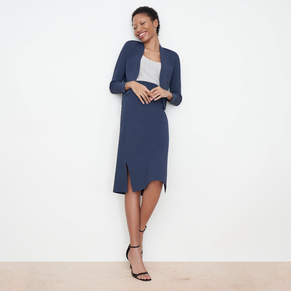 Front image of a woman standing wearing the Harlem skirt in jardigan knit in Baltic Blue