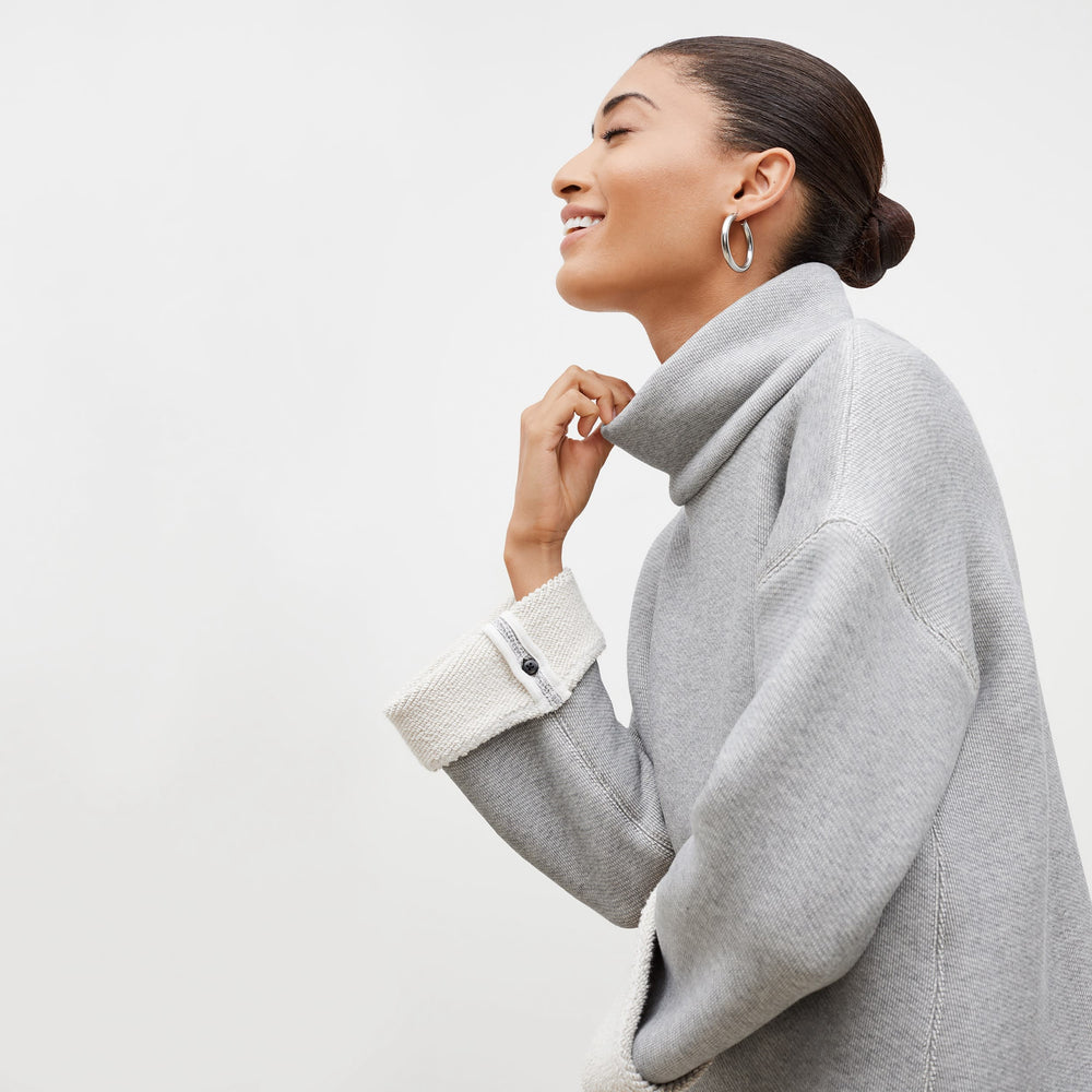 Side image of a woman standing wearing the Sharon Top—Plush Terry in Gray / Ivory