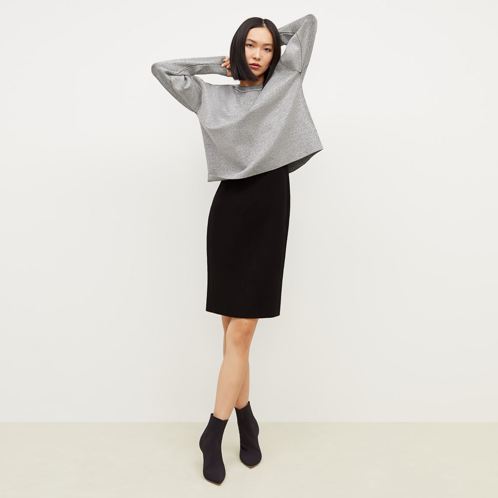 Front image of a woman standing wearing the Rachel dress in black