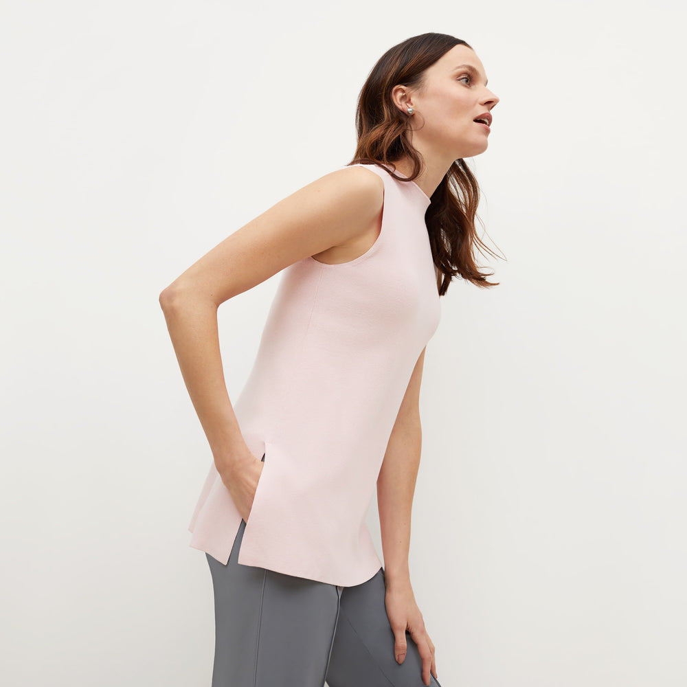 Side image of a woman standing wearing the Giulia Top—365Knit in Rosewater